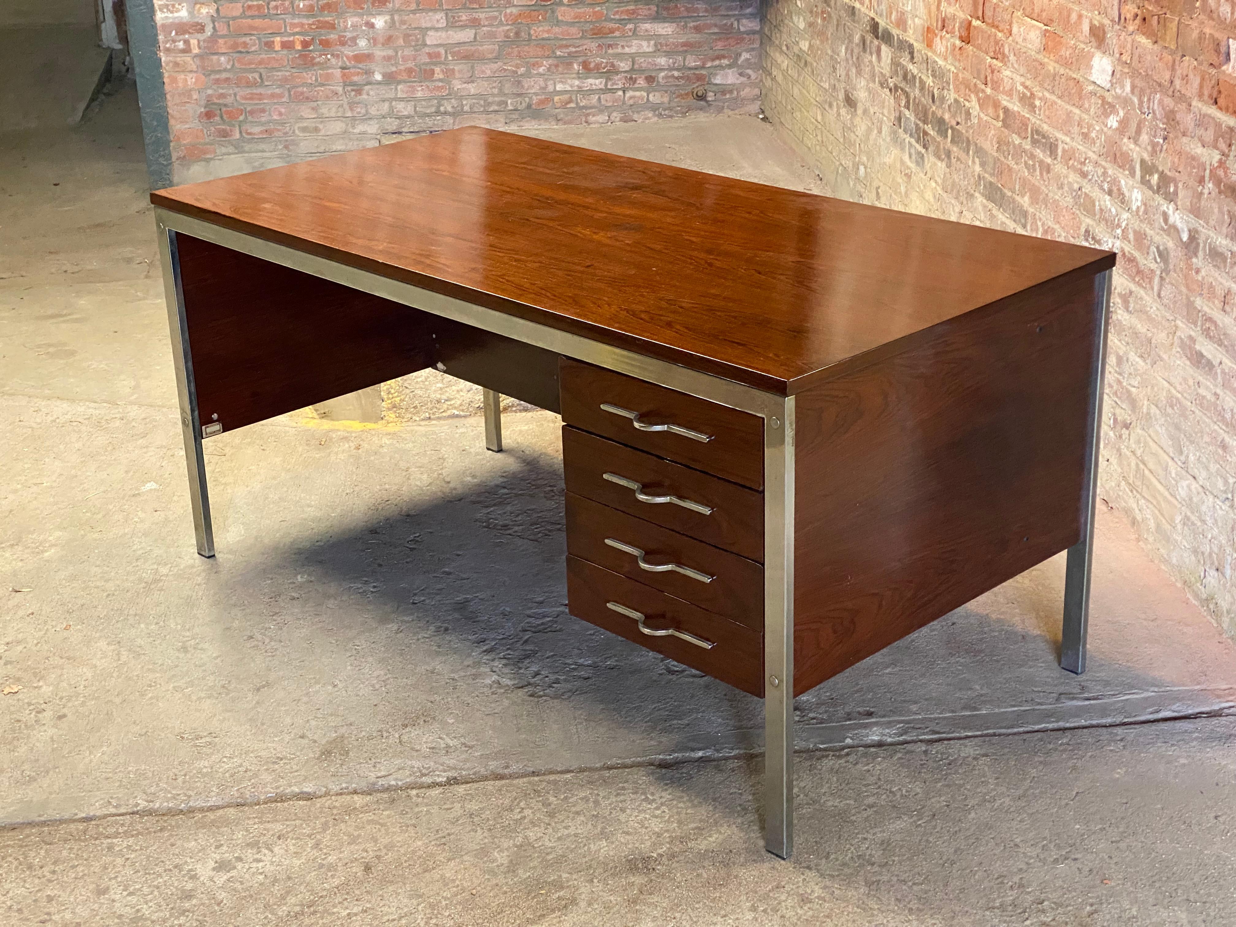 Large and roomy  Brazilian Jacaranda executive desk. Chrome legs and drawer hardware. The four drawers are flush right of the user. High and wide enough from the desk top for loads of legroom. Circa 1960-70. Signed with full paper label, Italia Wood