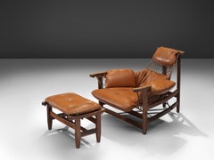Fauteuil de salon Jean Gillon Jangada avec pouf en cuir cognac