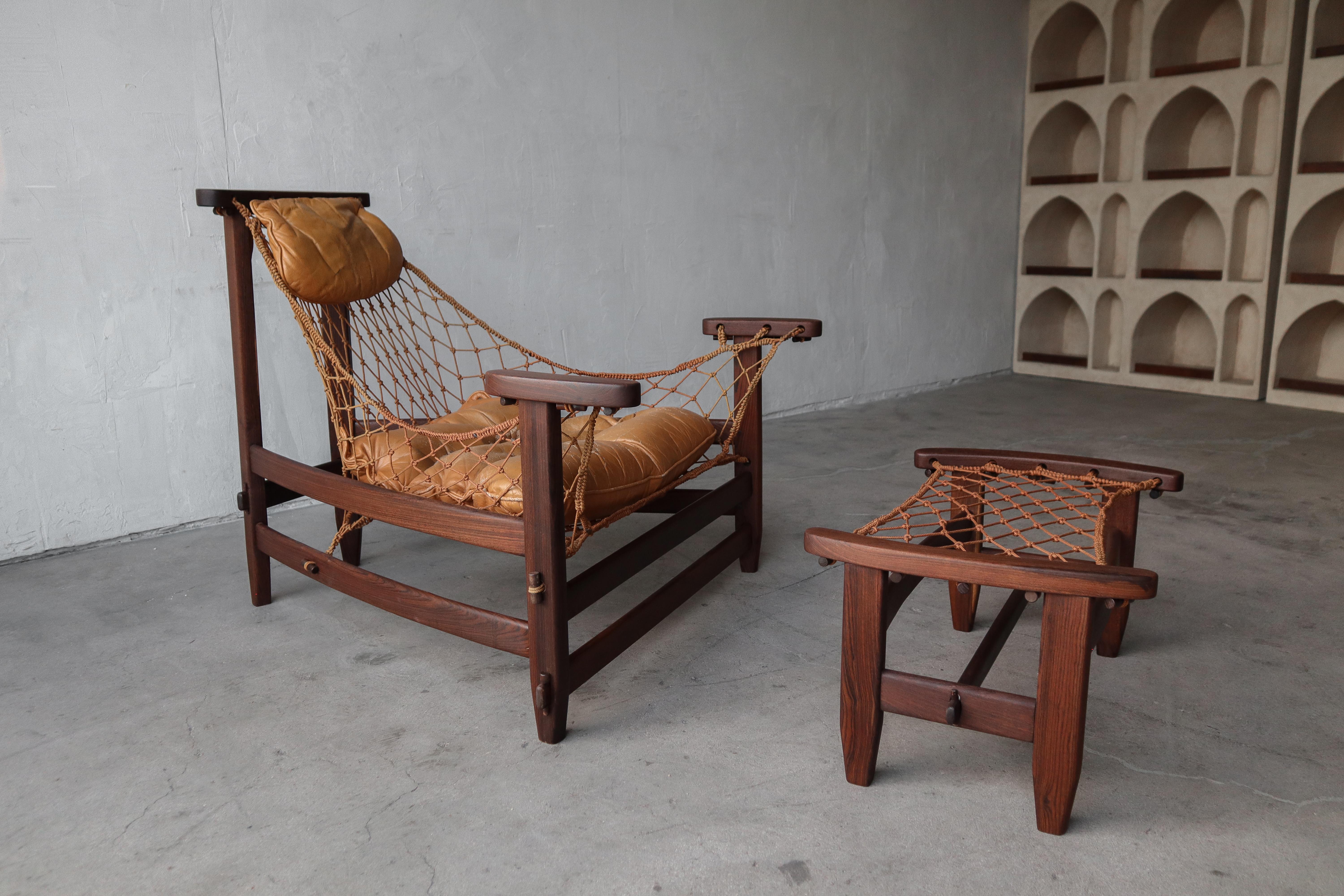 Highly sought after and ultimately collectible, this beautiful example of a Jean Gillon Jangada Lounge Chair and Ottoman is an EARLY model in RARE Brazilian Rosewood.  Our chair is all original, with its tag still in tact.  

The rosewood is frame