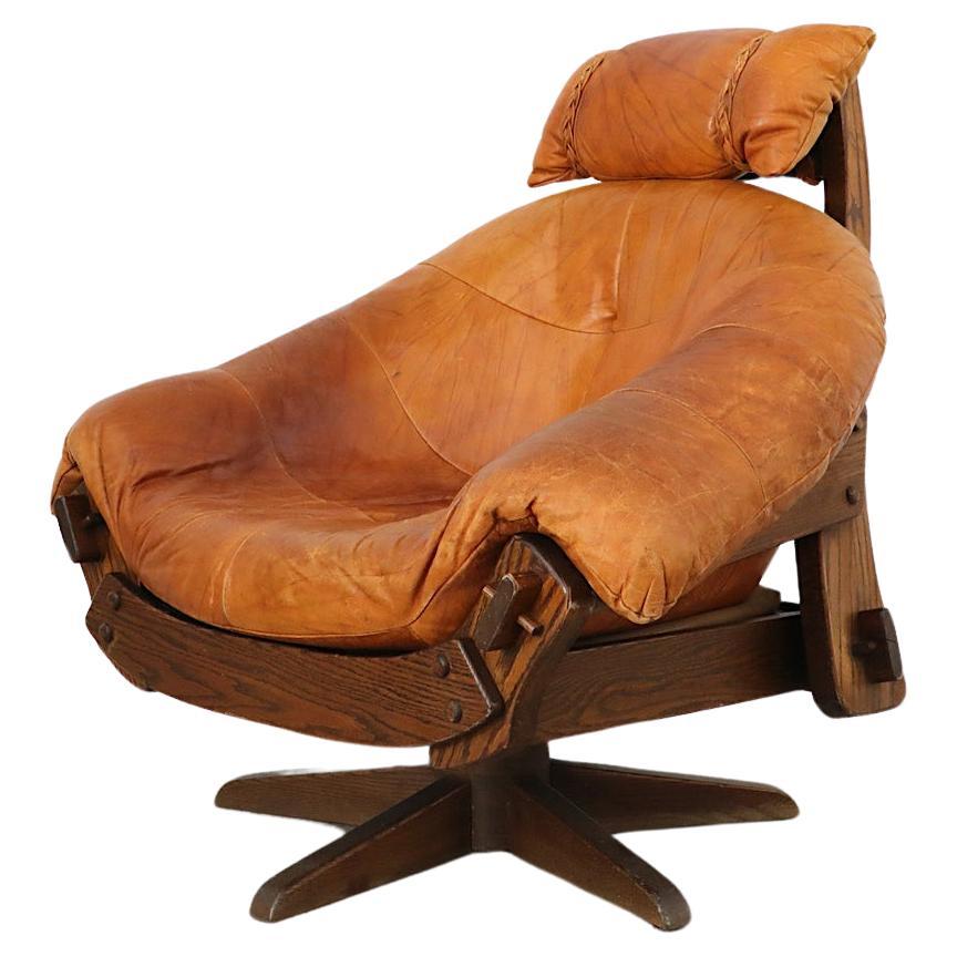 Jean Gillon Style Brutalist Cognac Leather and Oak Swivel Lounge Chair For Sale