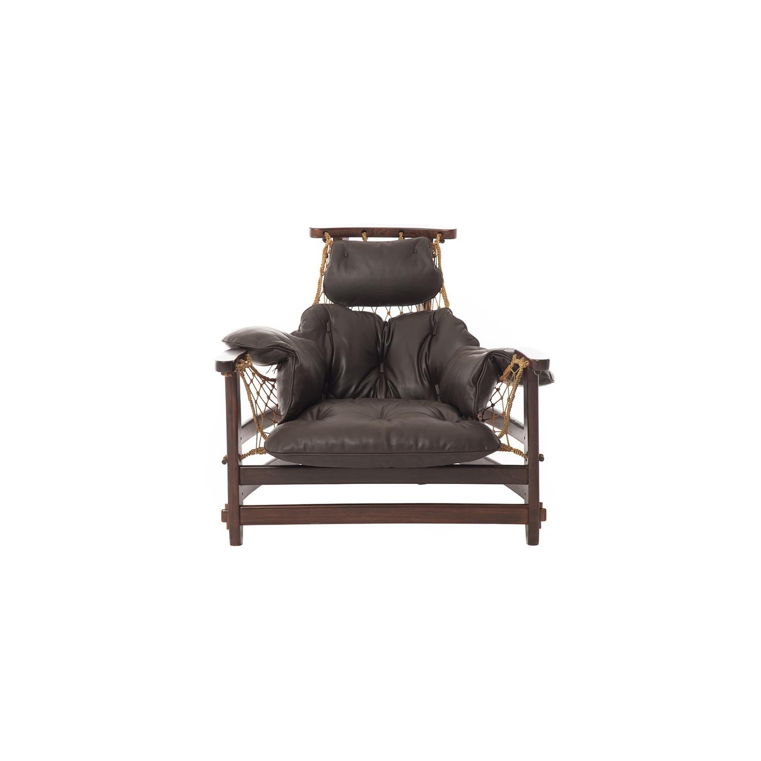 This show-stopping lounge chair and ottoman by Brazilian designer Jean Gillon starts with an angular rosewood frame adorned with a hand knotted, natural fiber sling. Leather cushions are new in a thick and supple deep brown, featuring rectangular