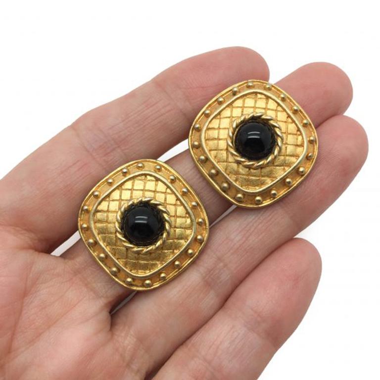 1980s Jean & Kuniko NYC Earrings. A classic pair of clips with a style edge, featuring chequered patterning, ball edging and black glass cabochons in 24ct gilded metal. In very good vintage condition, signed and measuring 2cm. Should you choose to