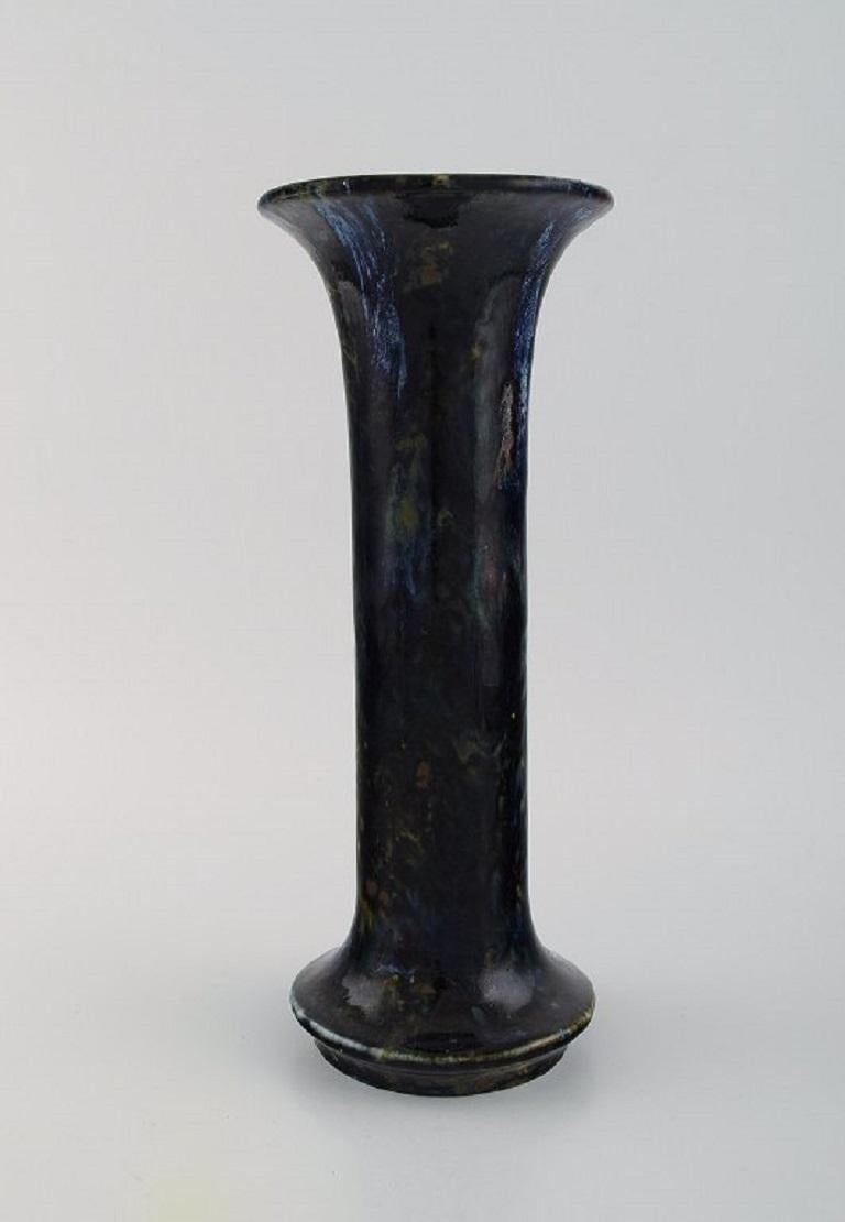 Jean Langlade (1879-1928), French potter. Vase in glazed ceramics. 
Beautiful glaze in black, ice blue and earth shades. 1920s.
Measures: 29 x 12 cm.
In excellent condition.
Signed.