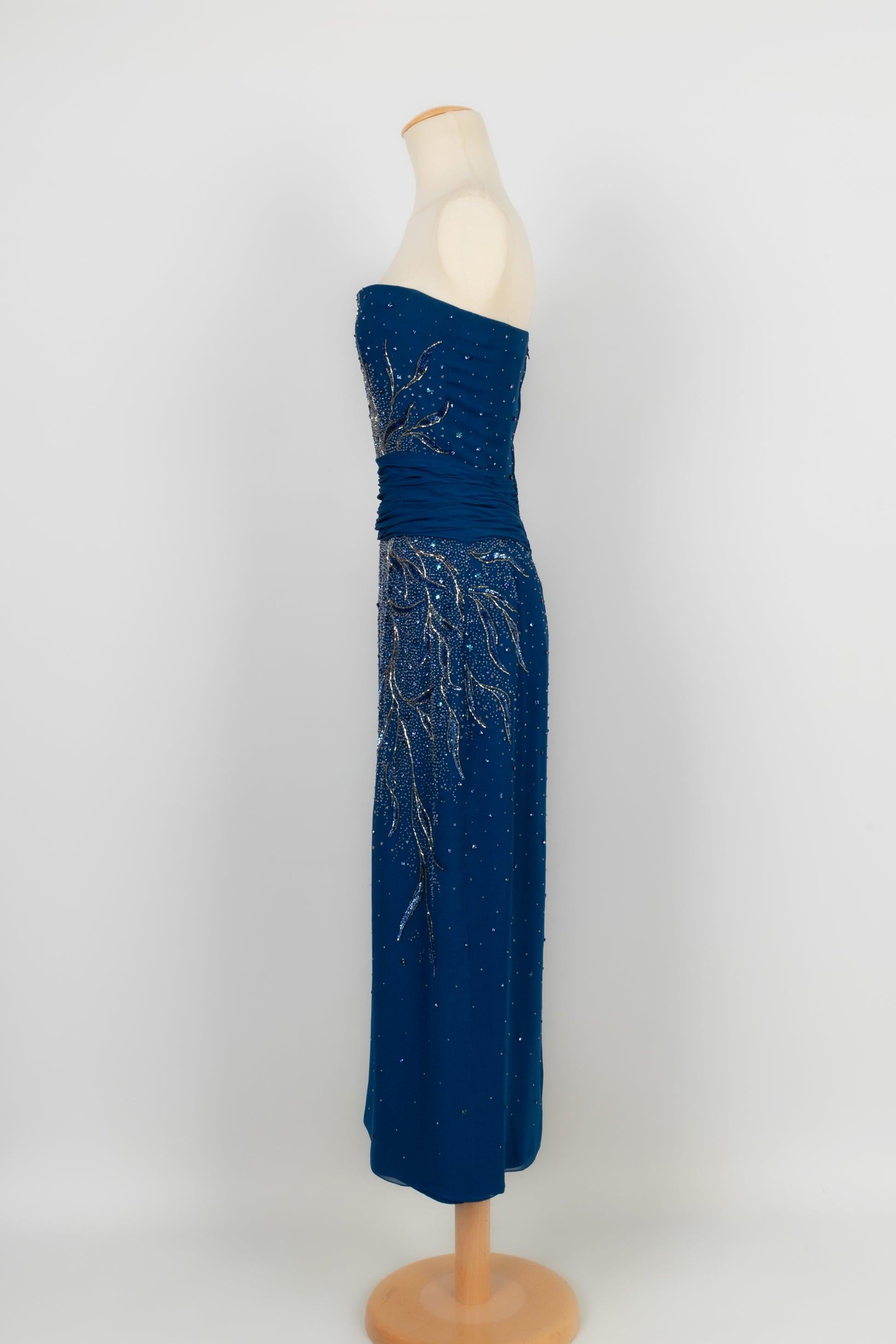Jean-Louis Scherrer - (Made in France) Blue crepe Haute Couture strapless dress embroidered with pearls and sequins in blue and golden tones. No size nor composition label, it fits a 36FR. To be noted, underarm stains.

Additional