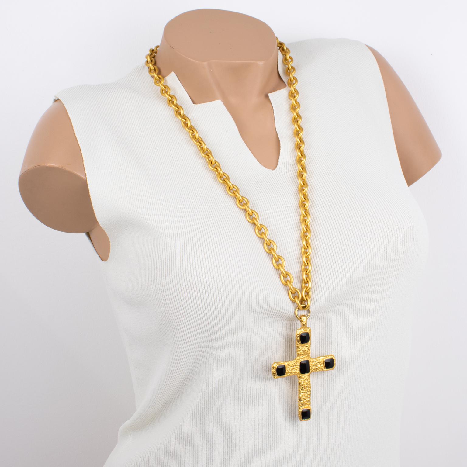 Jean Louis Scherrer Paris designed this lovely, typical 1980s-period pendant necklace. The piece boasts a heavy gilded metal chain with a satin finish ornate with a cross pendant. The modernist cross pendant is textured with a hand-made feel and