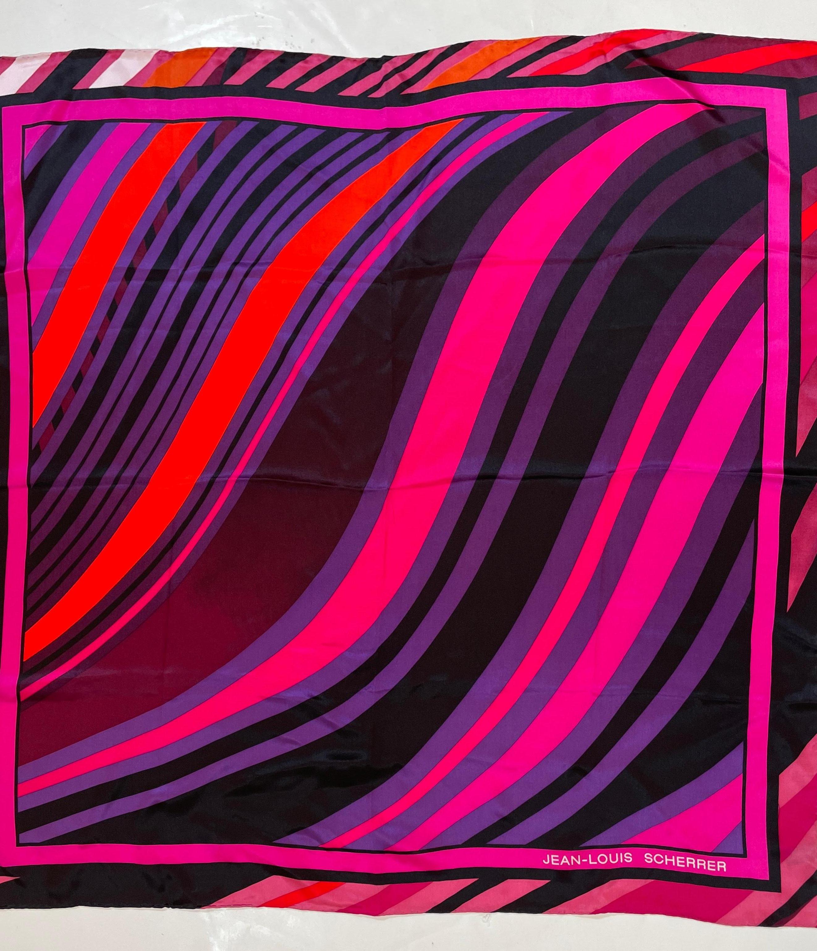 Jean-Louis Scherrer Paris Silk Scarf.
A genuine vintage silk scarf crafted by Jean-Louis Scherrer in the heart of Paris. This exquisite piece adorned with a charming abstract painterly design in hot pink, purple, and black design, creating a