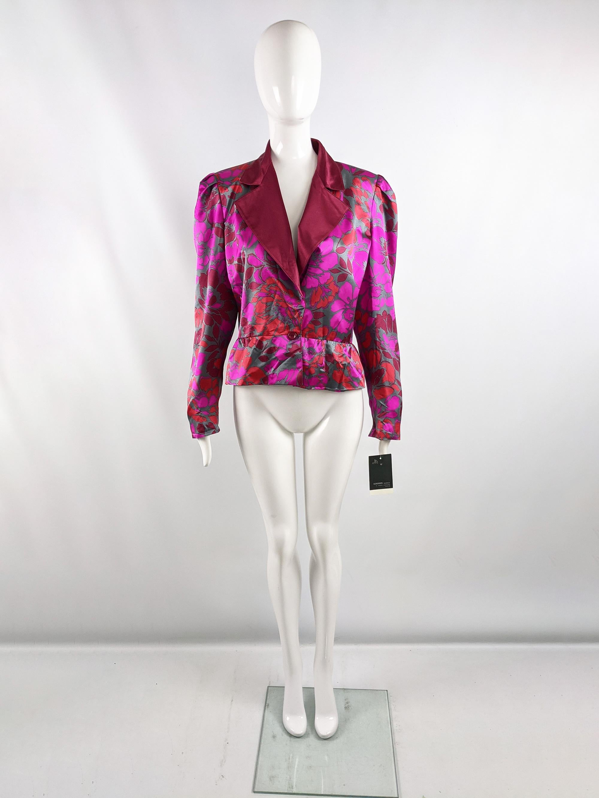 An amazing vintage womens blazer jacket from the 80s by luxury French fashion designer, Jean Louis Scherrer. Made in France, from a fuchsia, red and grey silk satin fabric with dramatic shoulder pads, a small peplum effect and wide lapels. Perfect