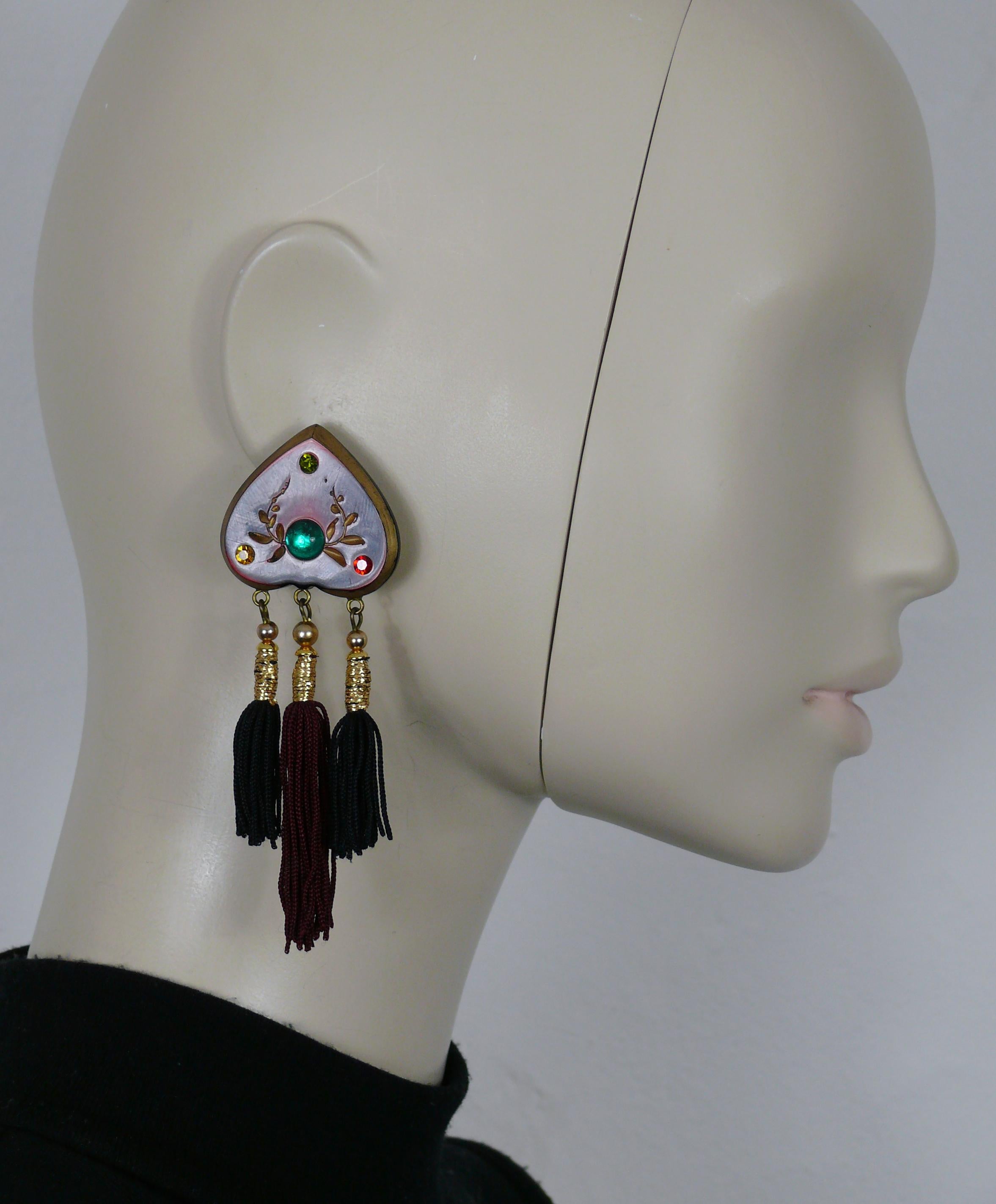 JEAN LOUIS SCHERRER vintage Russian inspired dangling earrings (clip-on) featuring a resin heart embellished with multi colored crystals and a green resin cabochon, three tassels (two in black color, one in burgundy color).

Marked SCHERRER Paris