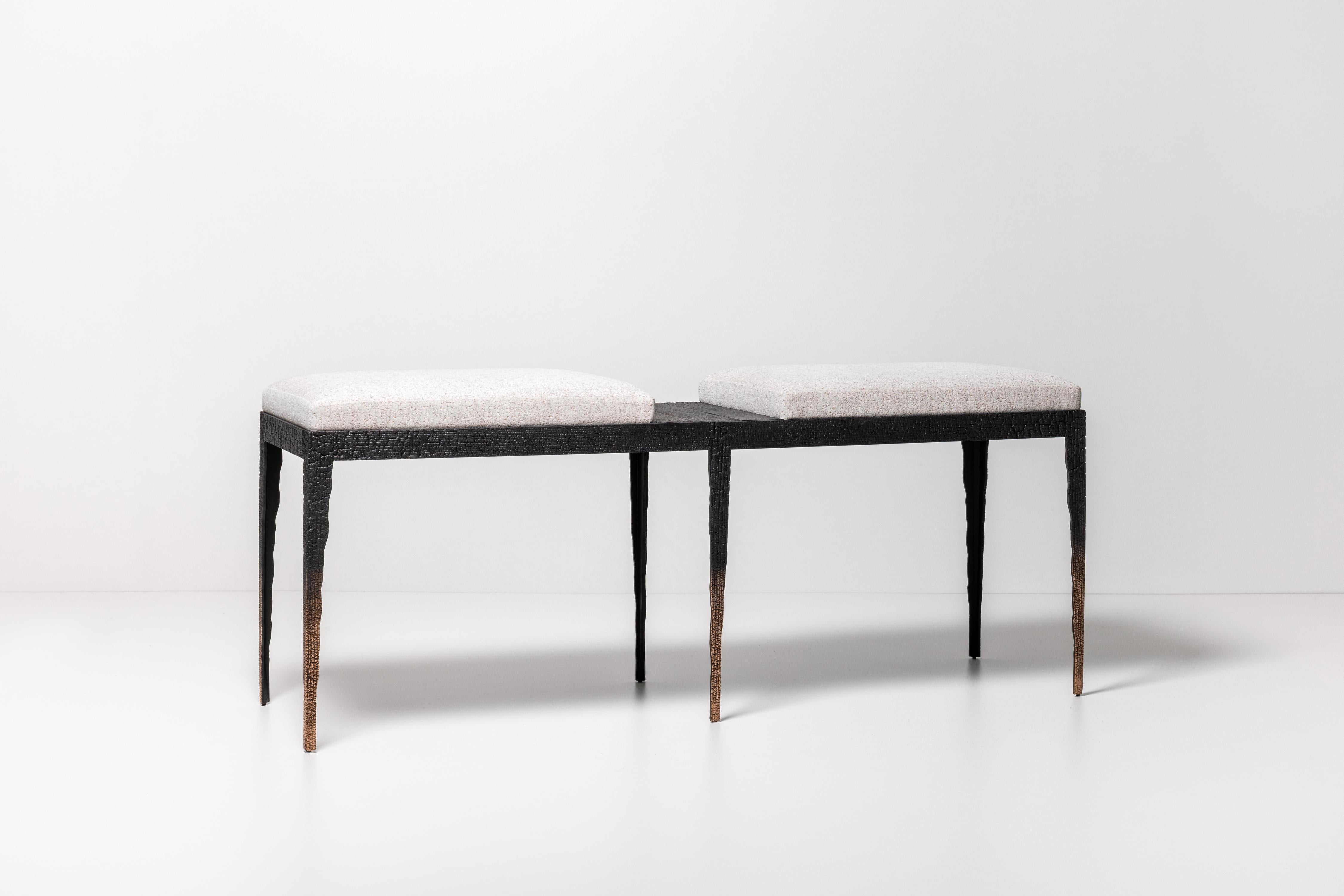 From his Empreinte Collection, a series of pieces centered around a theme of destruction and reconstruction, this six-legged bench is composed of patinated bronze cast from broken and burned wooden planks. Upholstered in an unbleached, structured