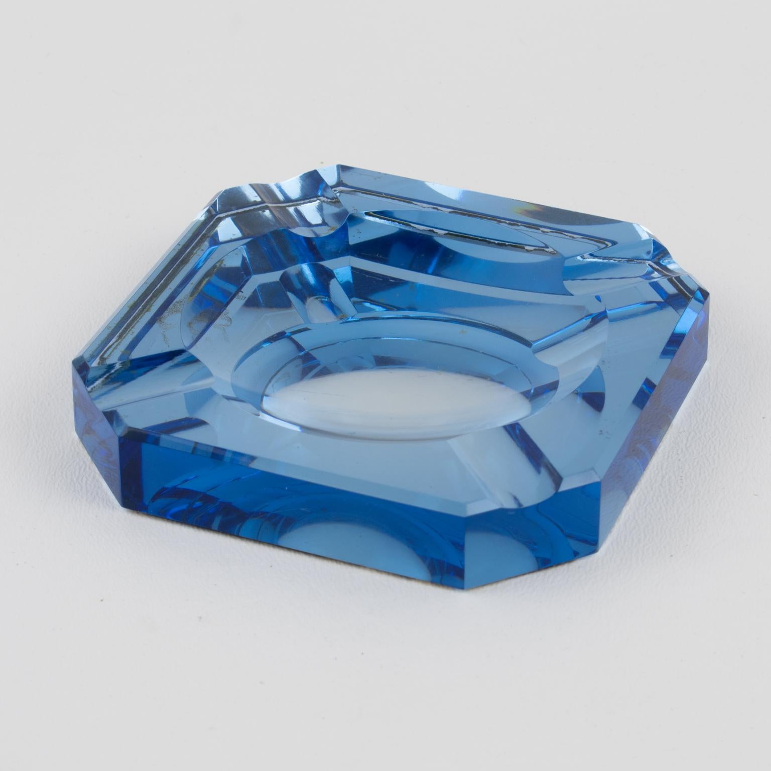 French designer Jean Luce (1895 - 1964) created this stunning Art Deco mirrored ashtray, desk tidy, or catchall in the 1930s. The vide-poche features a square shape with a thick blue mirrored glass slab and bevelling all around. There is no visible