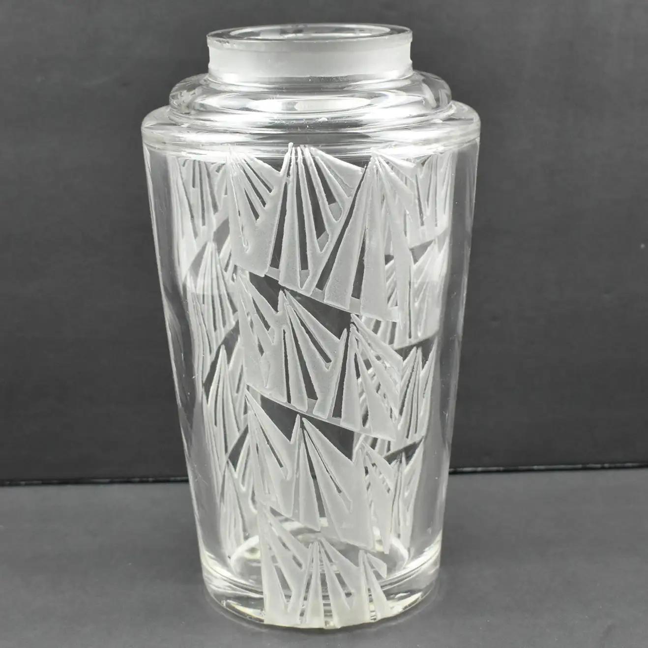 French designer Jean Luce (1895-1964) designed this handsome acid-etched glass vase in the 1930s. The geometric design has repeated decoration all around the vase. The signature is on the underside with the usual Luce monogram. 
The vase is in good