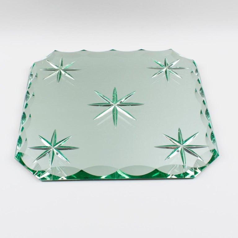 Stunning Art Deco mirrored tray, centerpiece, or platter by French designer Jean Luce (1895 - 1964). Extra thick mirror glass slab in a square shape with reverse carved star etched motif in the center and the four angles and cut corners with deep