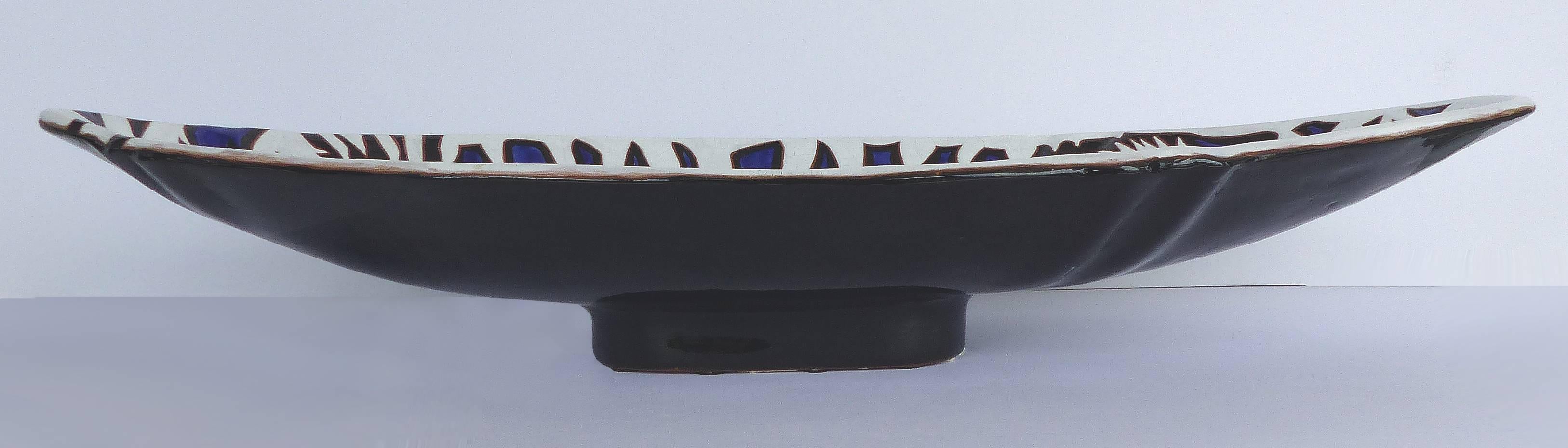 Offered for sale is an original Jean Lurçat glazed ceramic elongated footed tray produced at the atelier Saint-Vincent, France. Signed and numbered on the underside, this tray is 50 from an edition of 50 and dates from the mid-20th century.