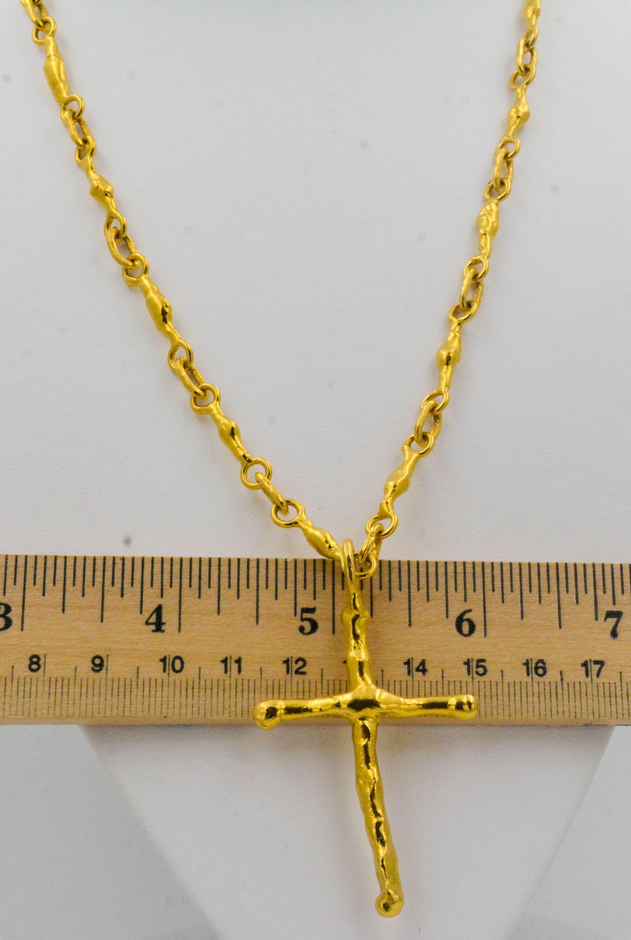 A stunning 1980's Jean Mahie 22 Karat Yellow solid gold cross combined with her signature free form primitive melt design link chain. This unique chain measures 21