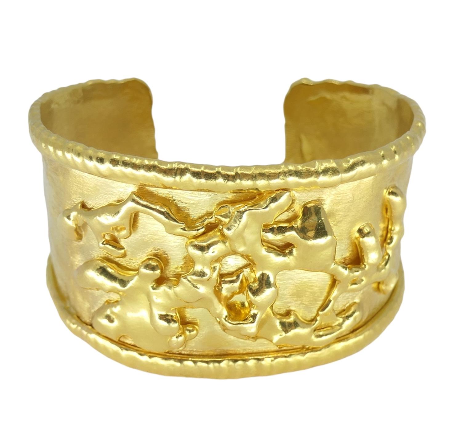 This Jean Mahie 22k yellow gold cuff bracelet is a stunning example of exquisite craftsmanship and timeless design. Marked with the signature of the esteemed jewelry maker, Jean Mahie, it boasts a rich golden hue that radiates sophistication. With