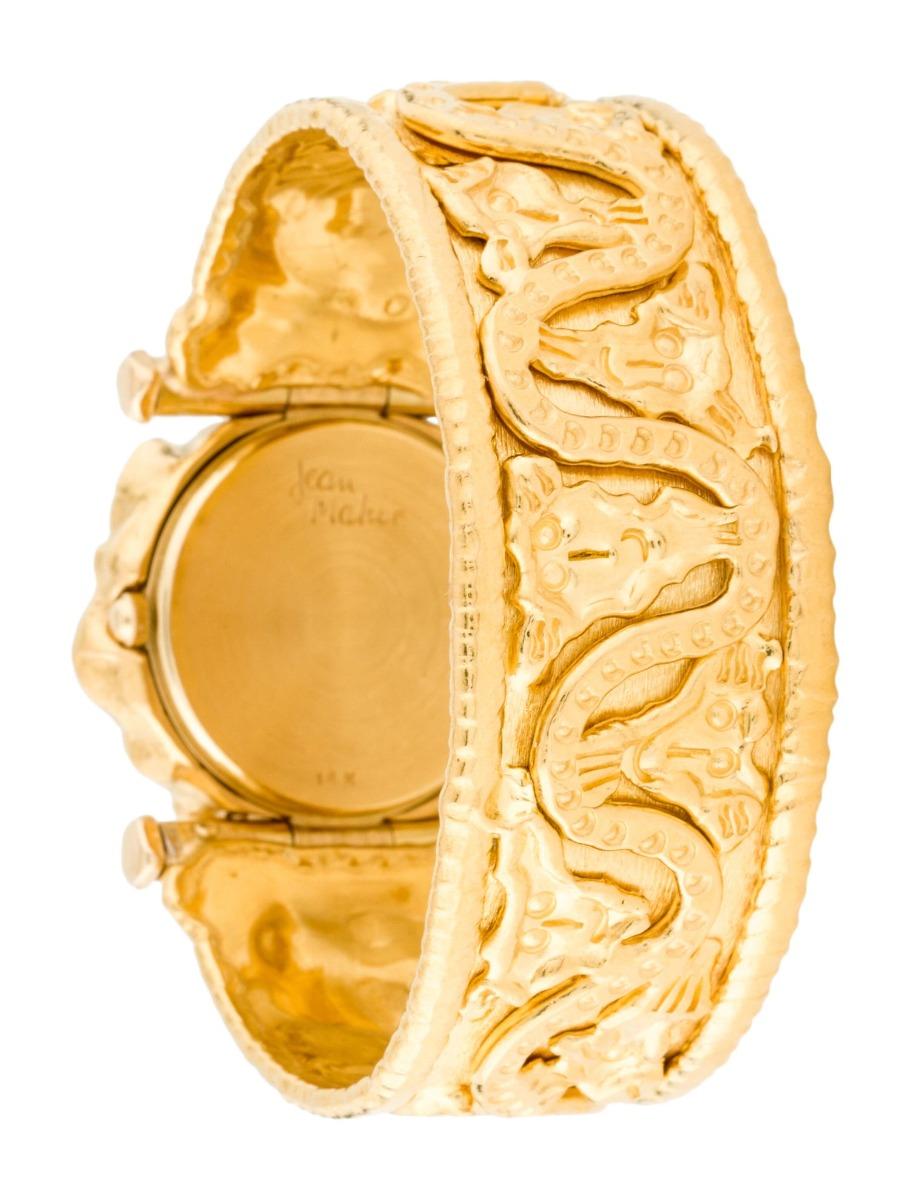 Jean Mahie 22K Ladies Watch - Quartz. 22K Yellow Gold with engraved bezel  ( 34 mm ). Textured gold dial. 22K Yellow Gold bracelet; Fits a wrist size of 6.25