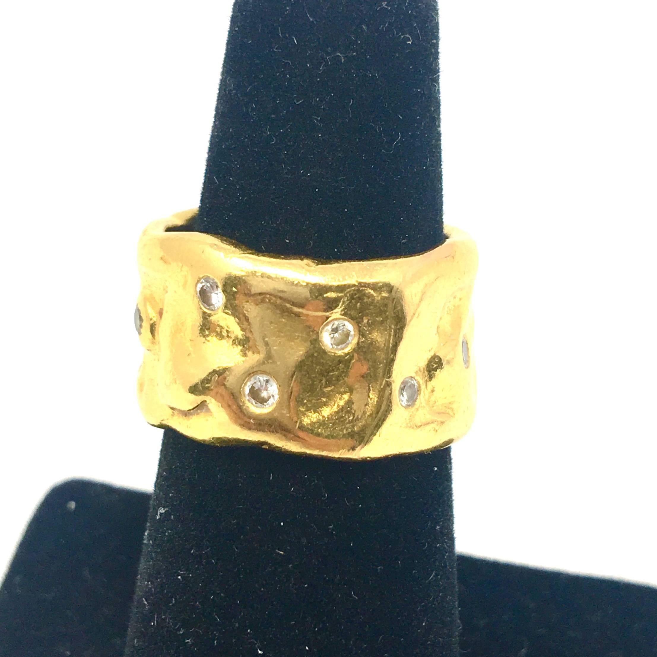 A Jean Mahie 22k yellow gold band. The ring has approximately .25ctw of diamonds.  Size 5.5