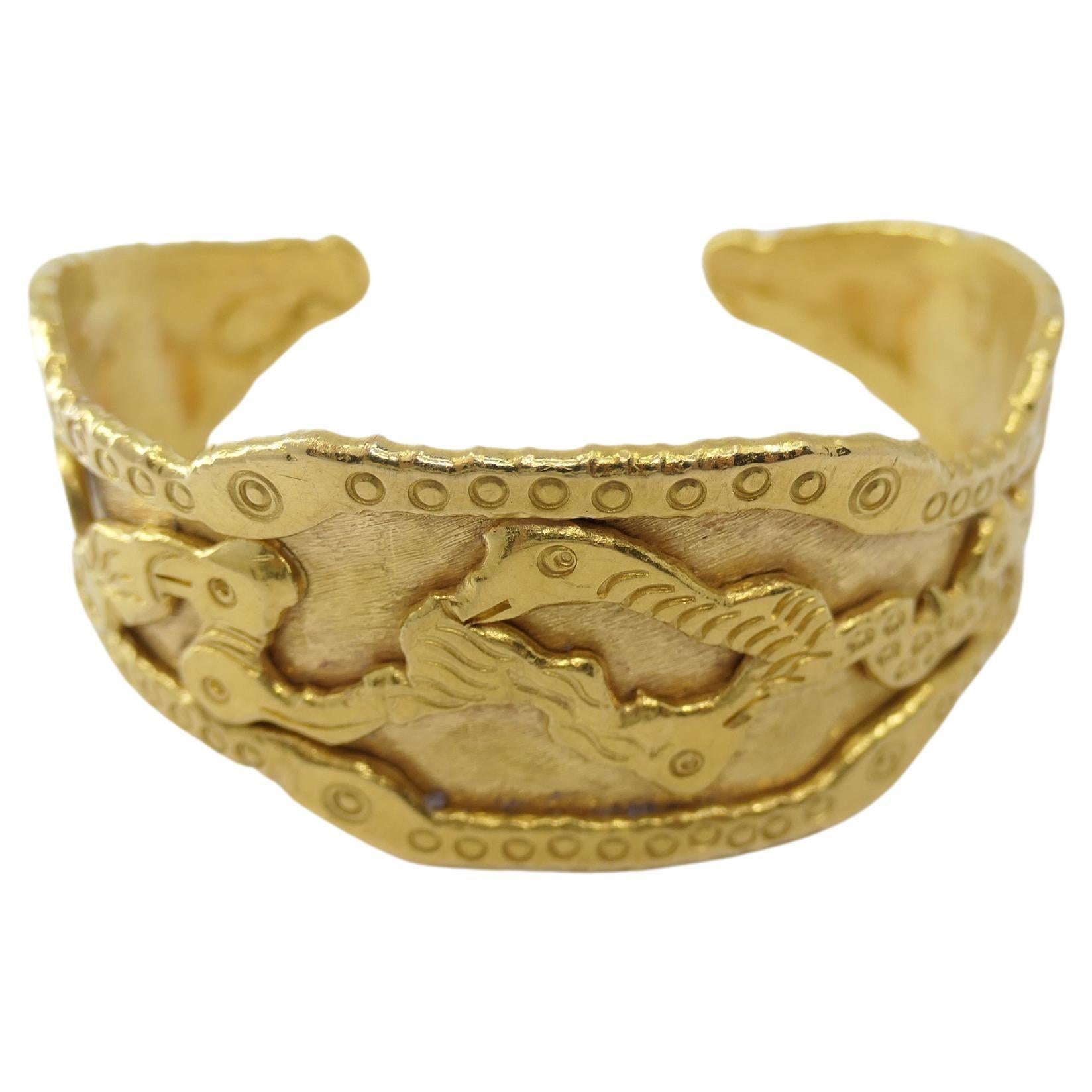 An amazing 22k gold cuff bracelet by Jean Mahie from Charming Monsters collection.
The bracelet has abstract design with the embossed carved  figures that resemble whimsical creatures. The pattern is created in Jean Mahie's artistic signature style