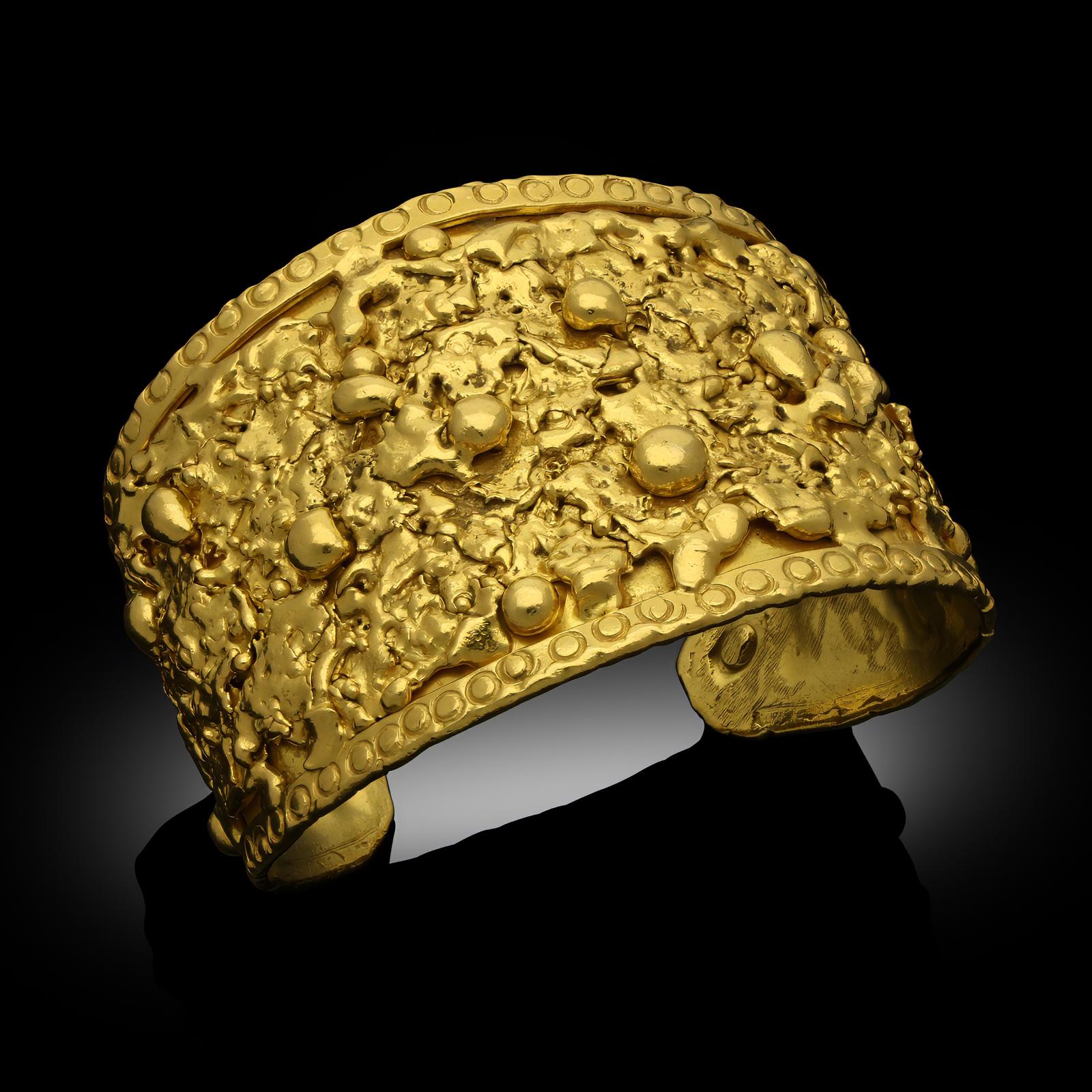 A vintage cuff bracelet in 22ct yellow gold, by Jean Mahie, circa 1970s. The wide cuff bracelet is designed to taper slightly towards the back and is designed with abstract, molten gold motifs between raised borders.
Maker
Jean Mahie
Period
circa