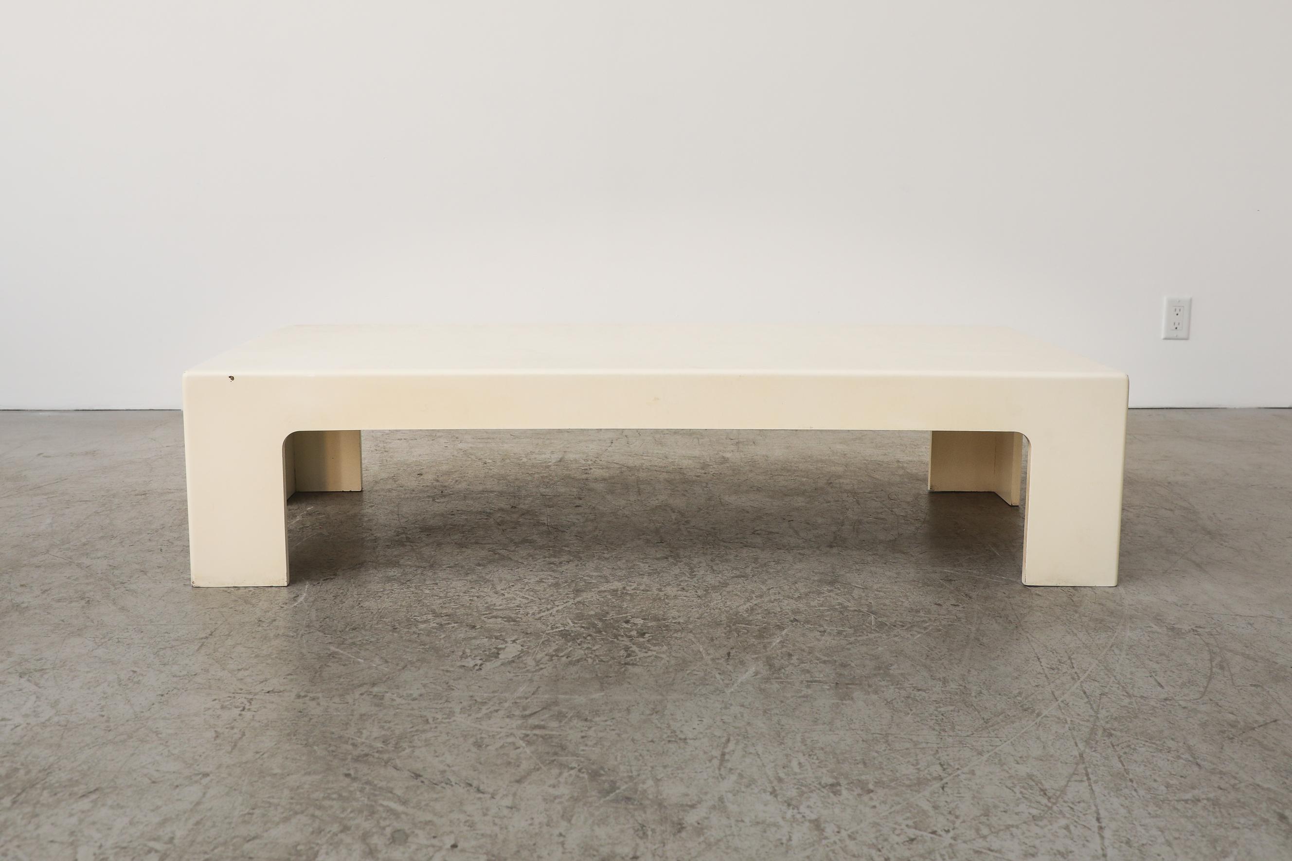 Jean Maneval Style MOD rectangle coffee table. Large bone white low and stealth coffee table made of molded composite material. In original condition with visible wear. including scuffing and chipping to the lacquer. Wear is consistent with its age