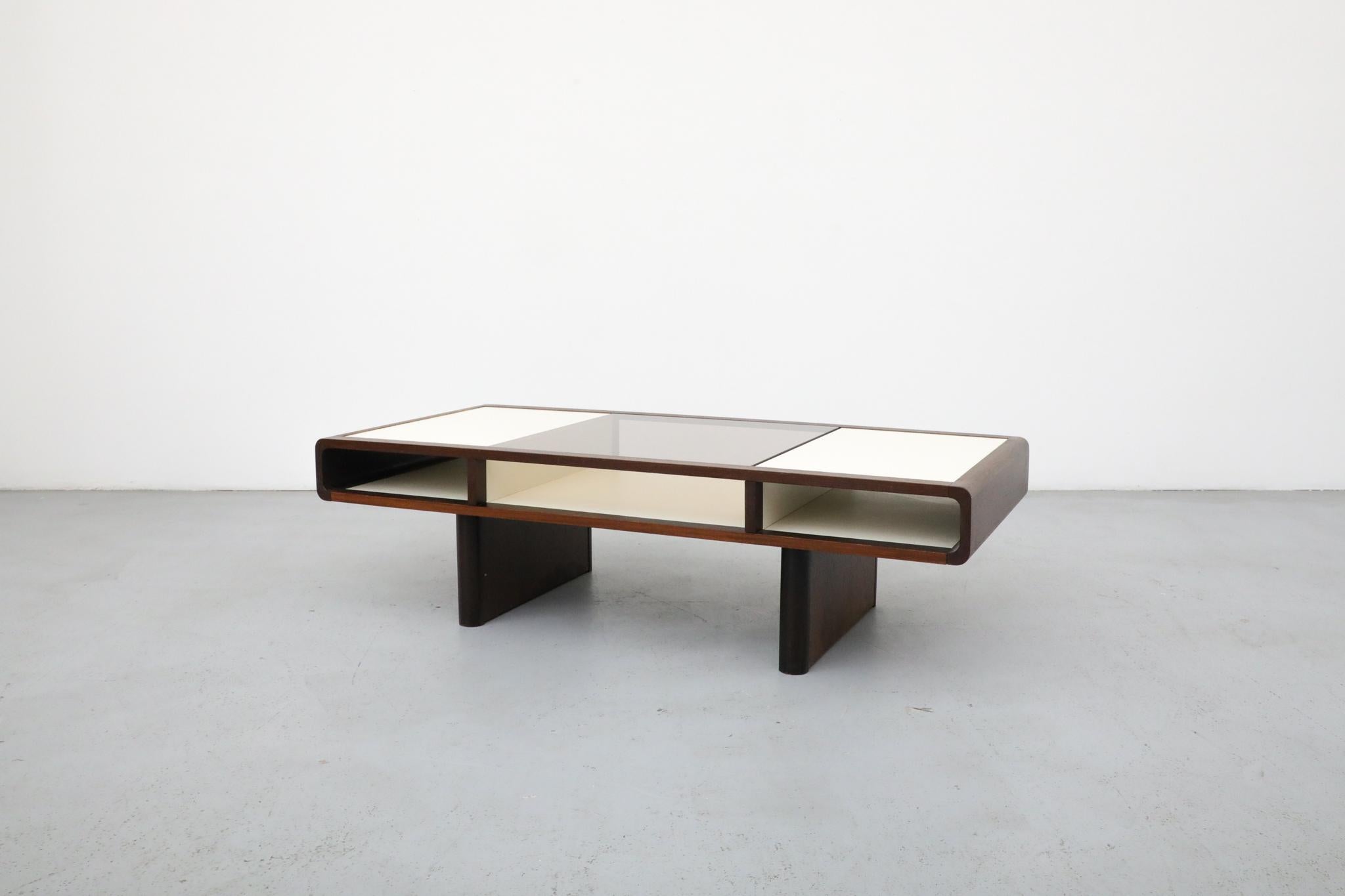 Jean Maneval Style Wenge and White Coffee Table with Bronzed Glass and Storage, France, 1970s
A compelling example of French Space Age design, this 1970s coffee table is executed in the style of Jean Maneval and reflects the experimental forms and