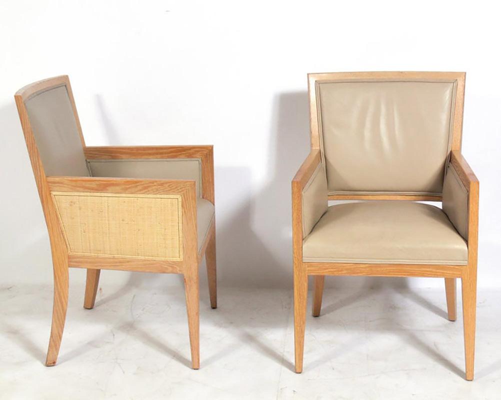 A pair of limed oak caned and leather upholstered armchairs, originally designed by Jean Michel Frank, circa 1930s. These examples are from a 1990s production by the company Mattaliano. They retain their warm original patina. The last period photo