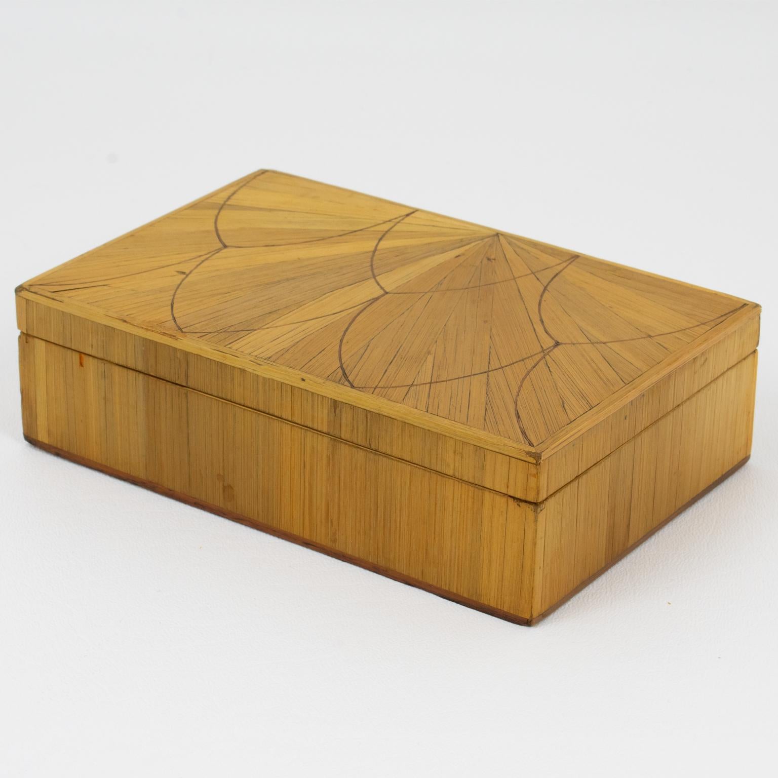 This rare Art Deco straw marquetry lidded box is attributed to French designer Jean Michel Frank. The piece was crafted in France circa 1930. The rectangular shape is stunning, refined geometric, and the interior is lined with dark wood. The