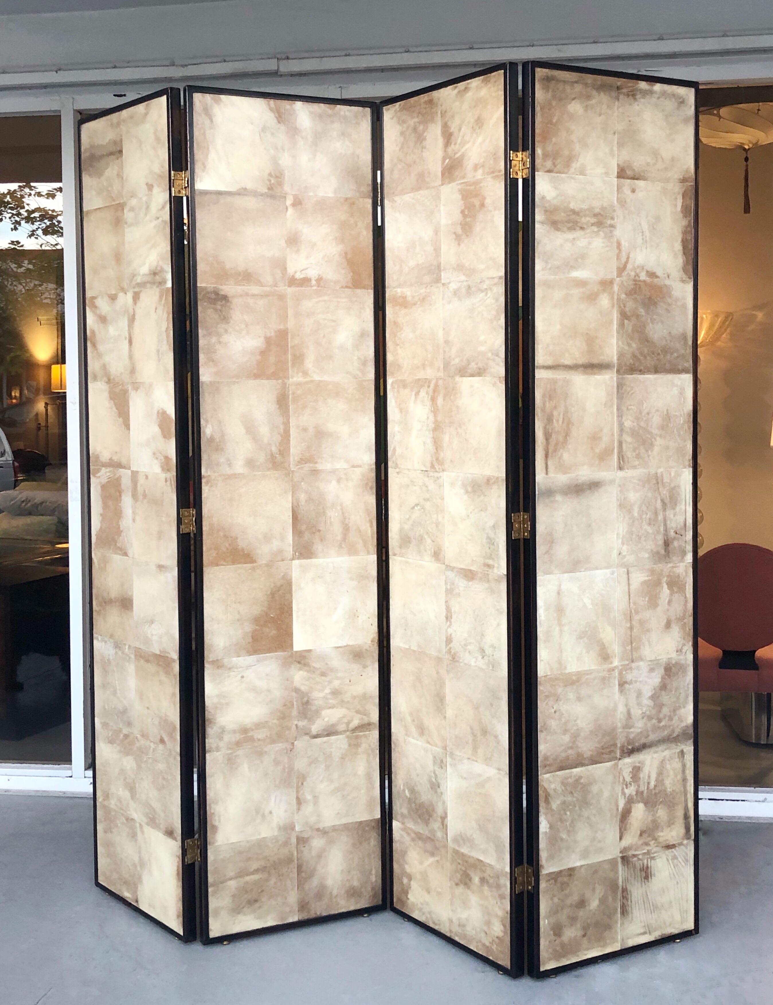 A large 4-piece screen. Wood, covered with parchment squares. Screen is finished on both sides. The hinges allow for the screen to be folded both ways.