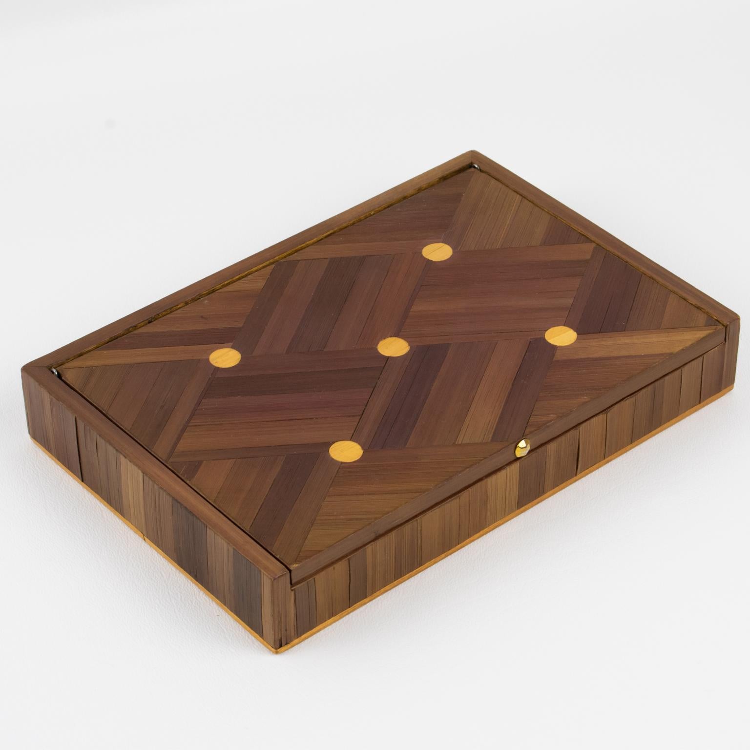 This is a lovely Art Deco straw marquetry decorative lidded box whose design is attributed to Jean Michel Frank (1895 - 1941). The rectangular shape has a refined geometric design, and the interior is lined with cork. There is no visible maker's