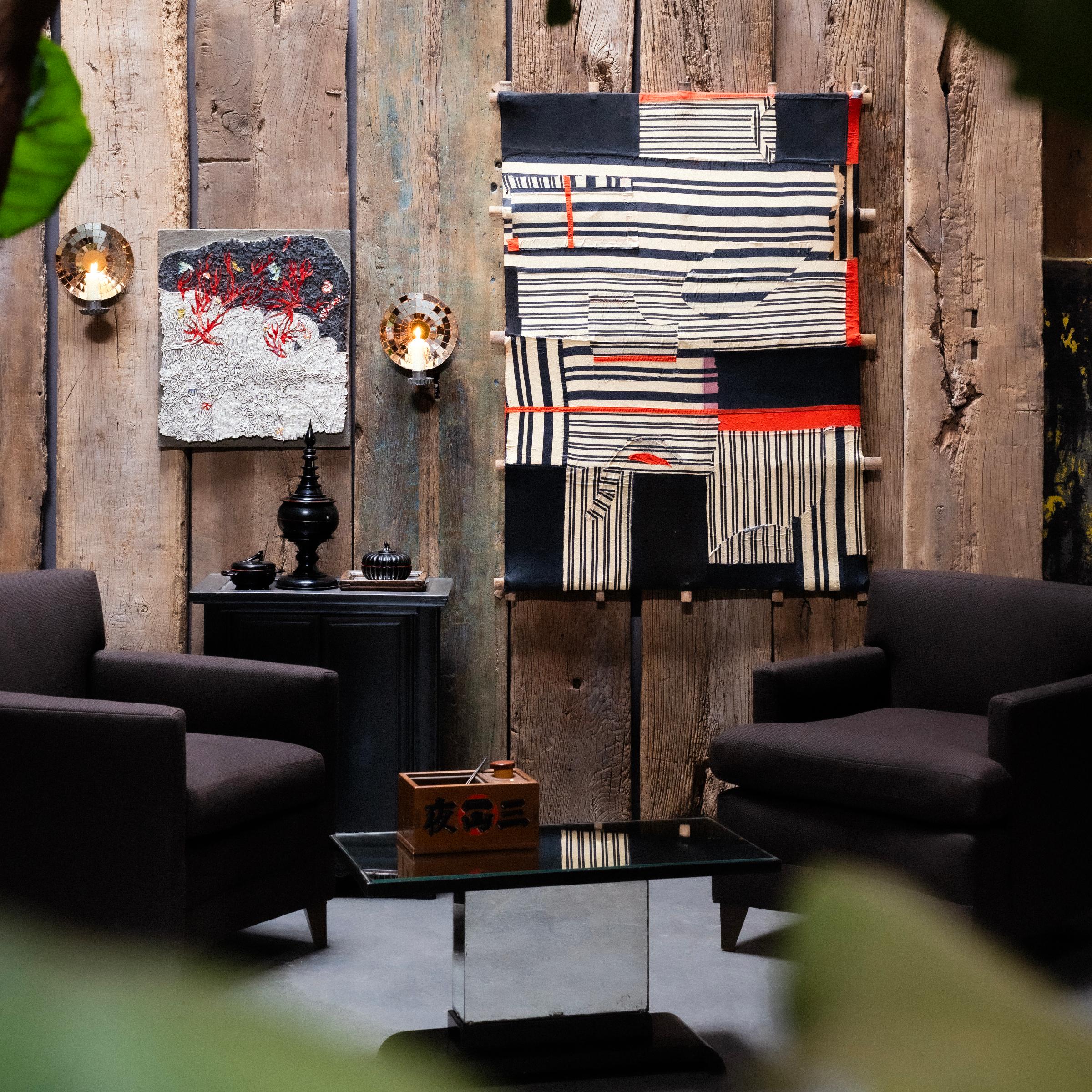 A cushioned armchair in the style of Mid-Century Modern, recently updated by Chicago design firm Yung Atelier with cotton blend upholstery in a neutral, espresso brown. The armchair's angular silhouette and minimal simplicity are reminiscent of the