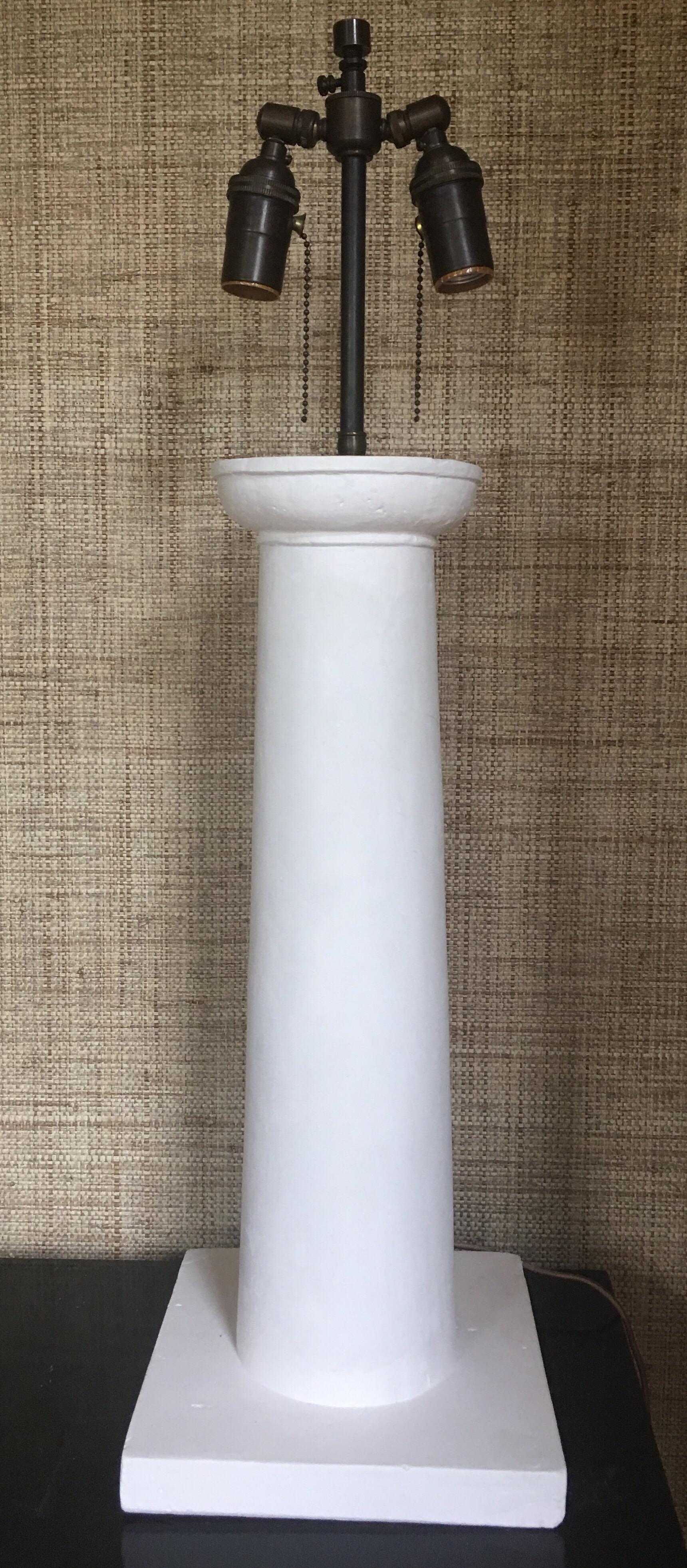 Jean-Michel Frank style Colonne matte white heavy weight molded plaster table lamp. Bronzed metal accents feature two double articulating standard sockets and an adjustable height shade extender finial. Extra long 8 foot fabric covered cord. Custom