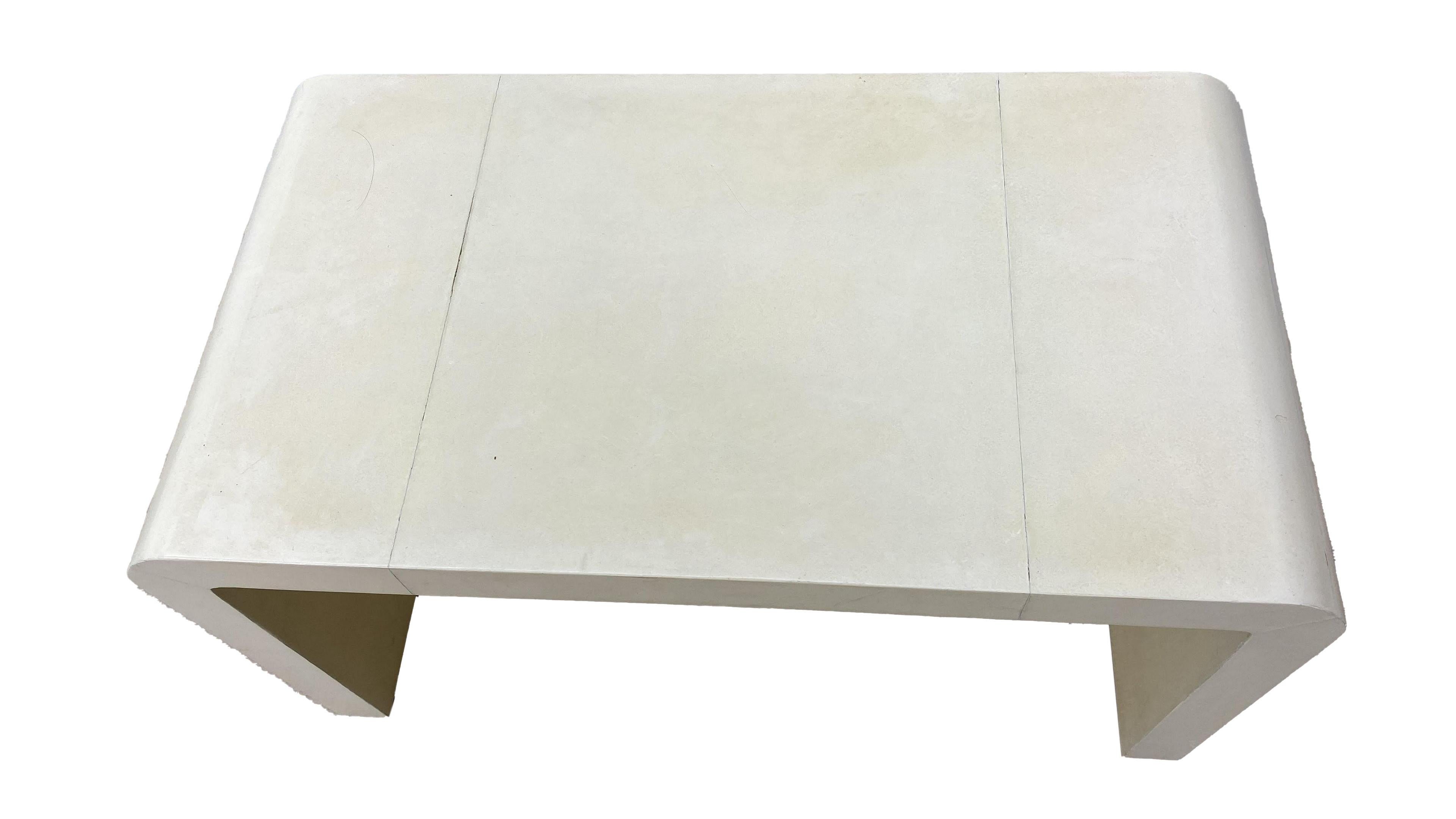 Jean-Michel Frank style waterfall coffee table not signed, but could be an original. It is covered in original goatskin parchment. Beautiful addition to any decor.