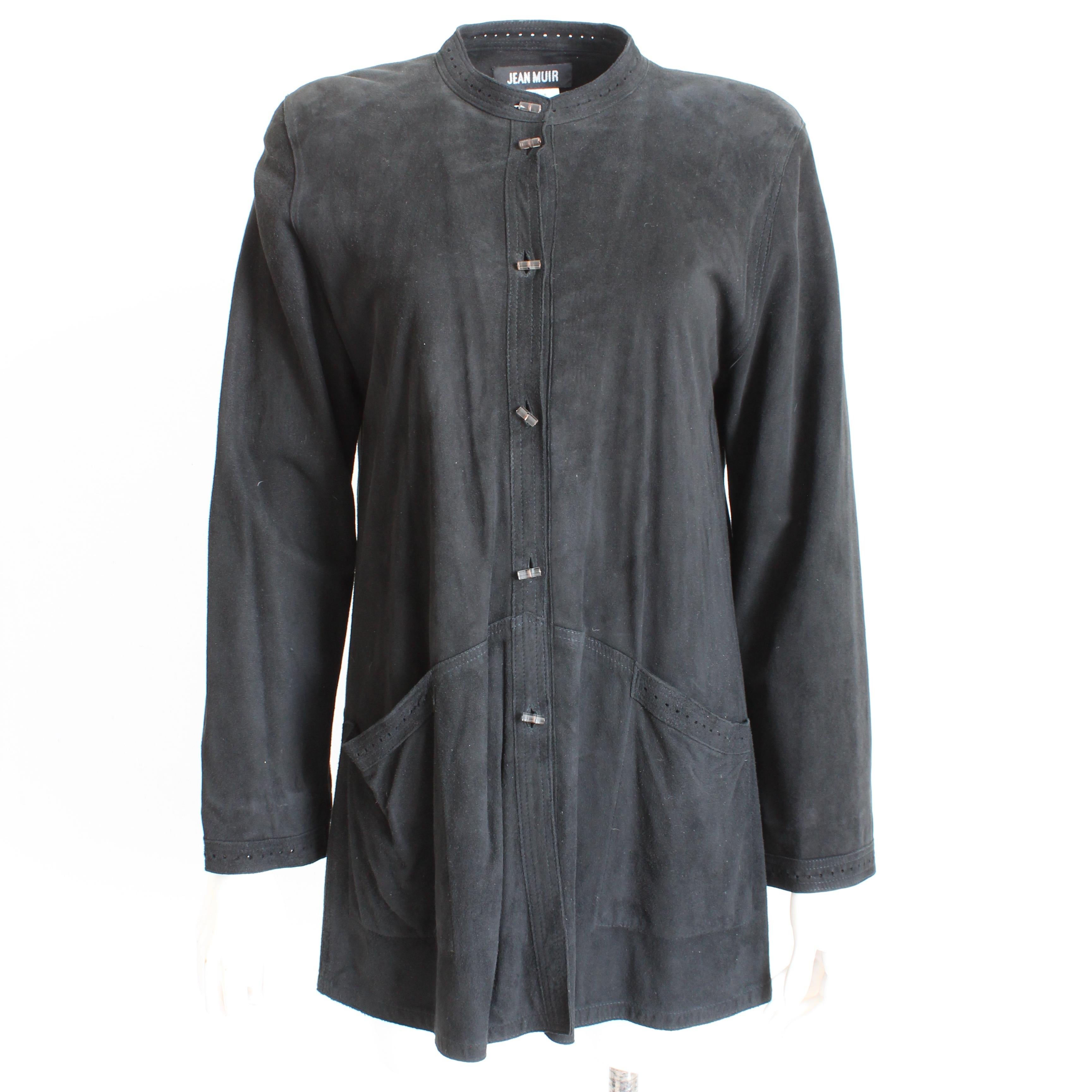This incredibly supple black suede jacket was designed by Jean Muir in the late 1970s.  Made from black suede leather, it fastens with lucite barrel buttons and has a perforated border at the collar, hip pockets and sleeve bottoms.  Fabulous and