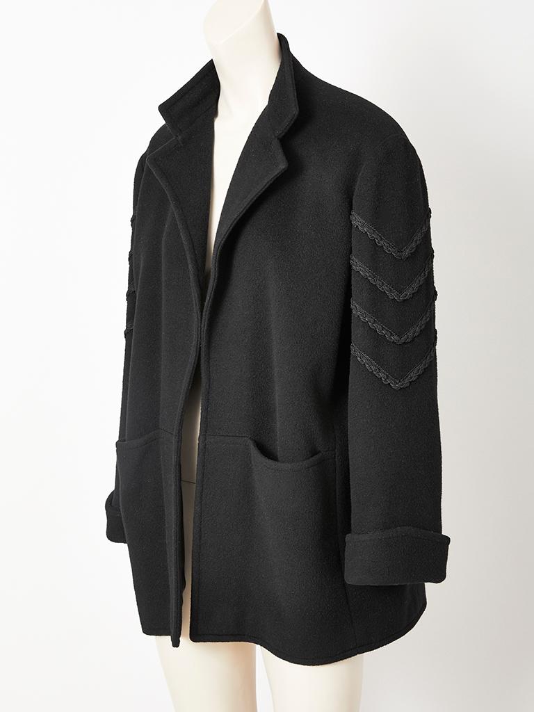 Jean Muir, black wool, jacket having a notched collar,  large patch pockets, no closures and passementerie detail on the sleeves.