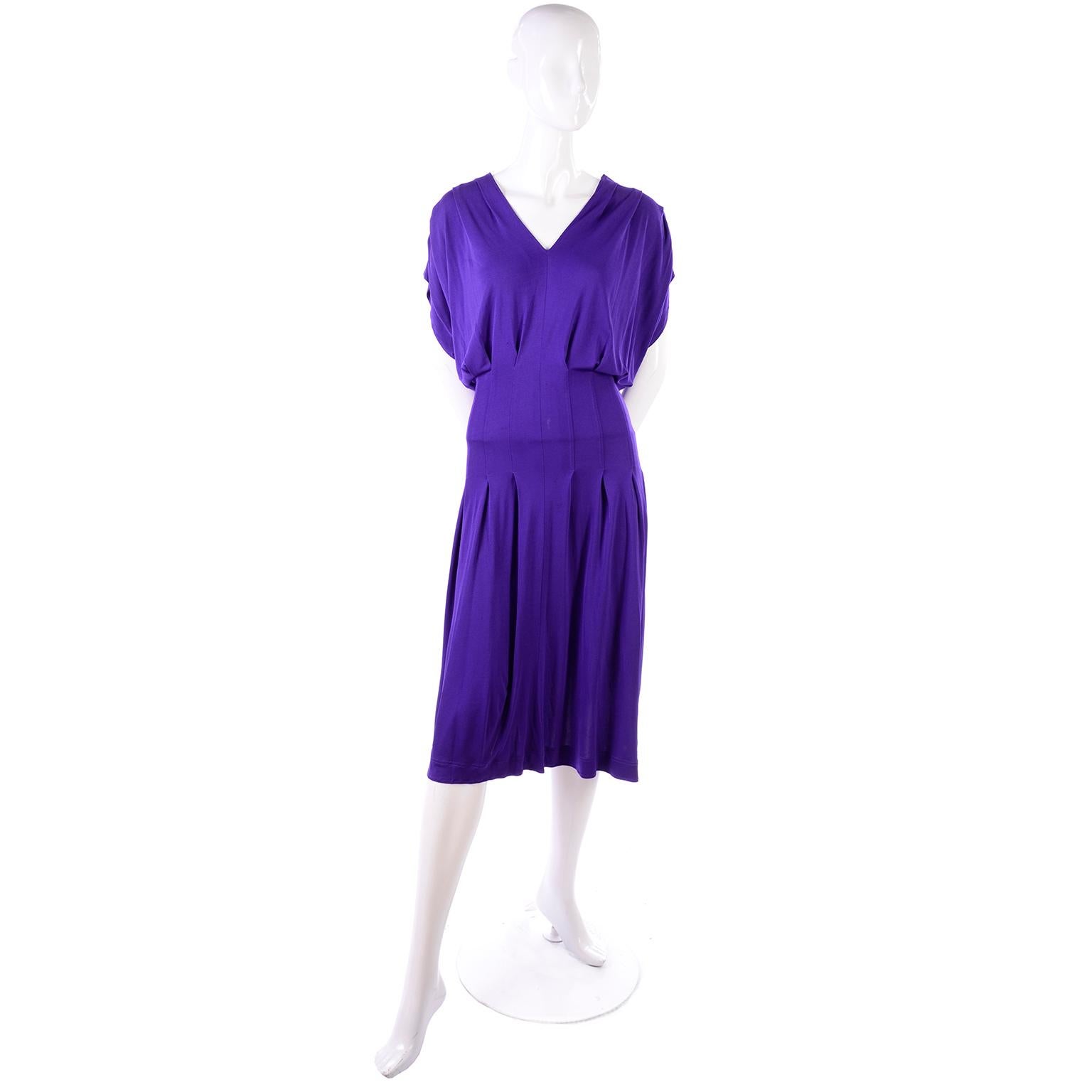 This is a great late 1970's or early 1980's vintage dress from Jean Muir, London. The dress is in a purple rayon jersey and has gathered dolman style short sleeves and a V neck.  The dress is marked as an 8, but because of the loose fit, it can fit