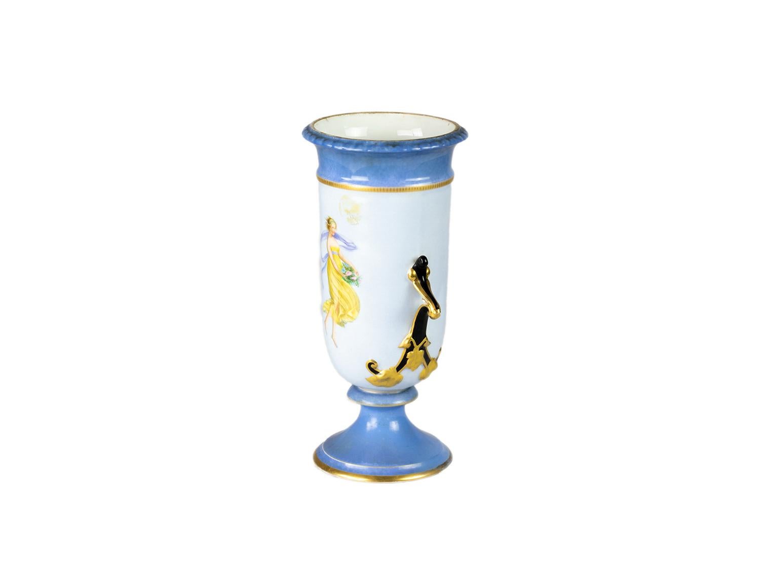 This magnificent Napoleon III porcelain vase showcases a stunning royal cobalt blue hue, adorned with a timeless yellow dress costume with a Nast mark.