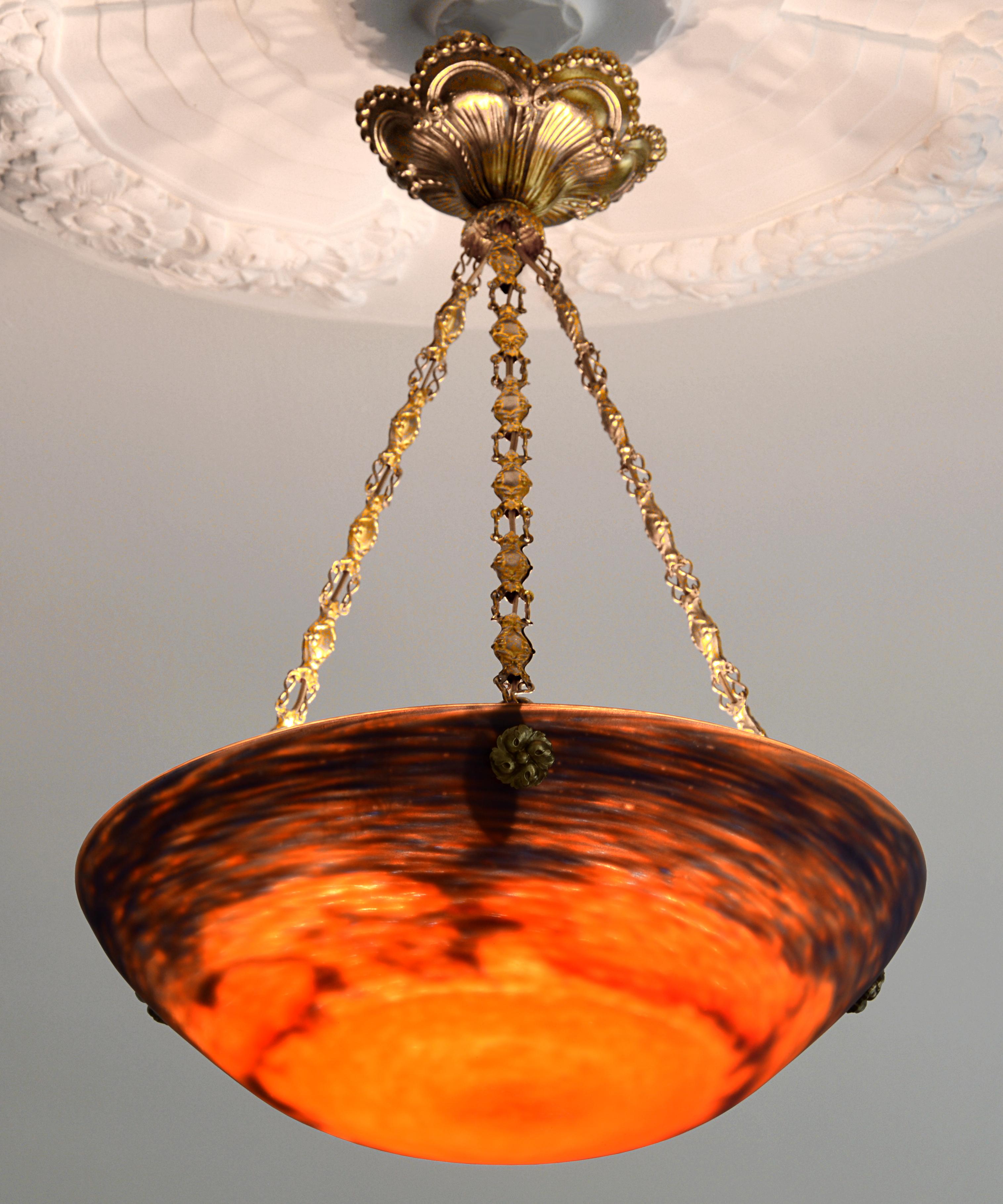 French Art Deco chandelier by Jean Noverdy (Dijon), France, late 1920s. Glass and brass. Mottled blown thick double glass shade. Colors: dark blue, orange and red. Original stamped brass frame. Signed 