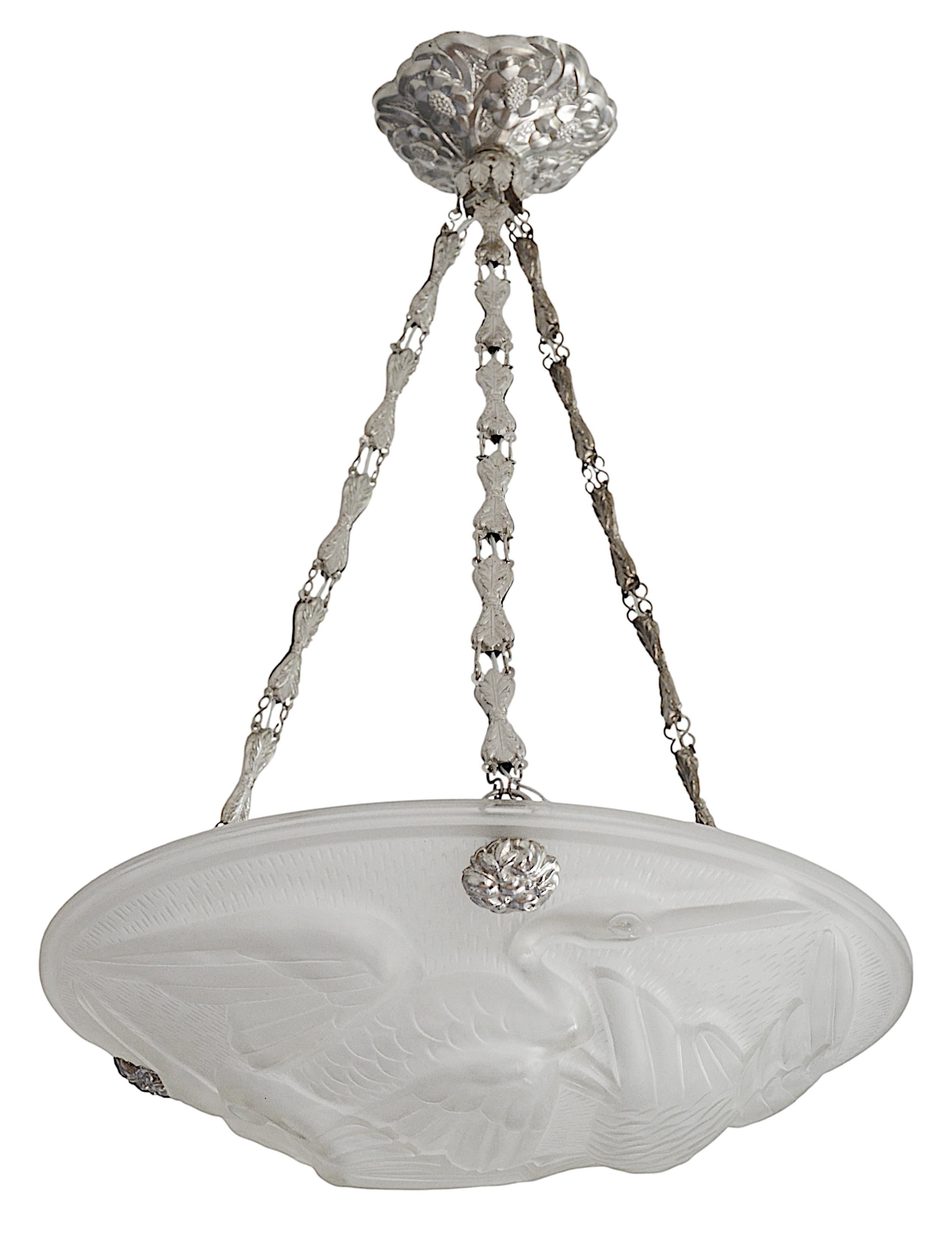 French Art Deco pendant chandelier by Jean Noverdy (Dijon), France, late 1920's. Frosted molded glass shade showing three storks. Silver-plated stamped brass frame. Height : 20.5