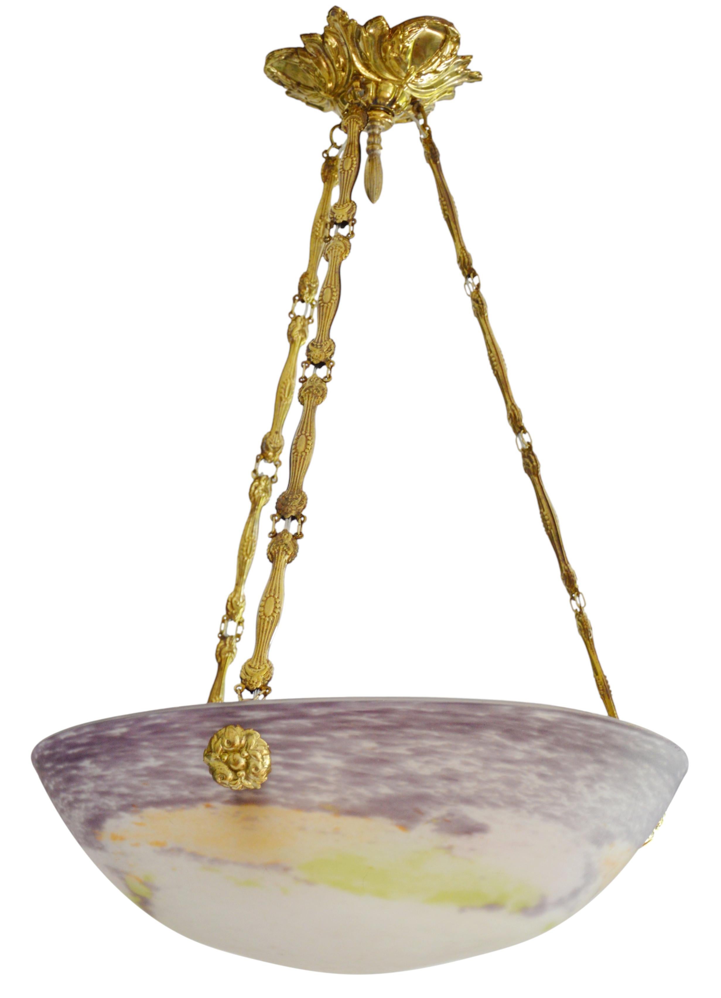French Art Deco pendant chandelier by Jean Noverdy (Dijon), France, late 1920's. Mottled blown thick double glass shade. Colors : purple, ochre and green. Stamped brass fixture. Height : 20.1
