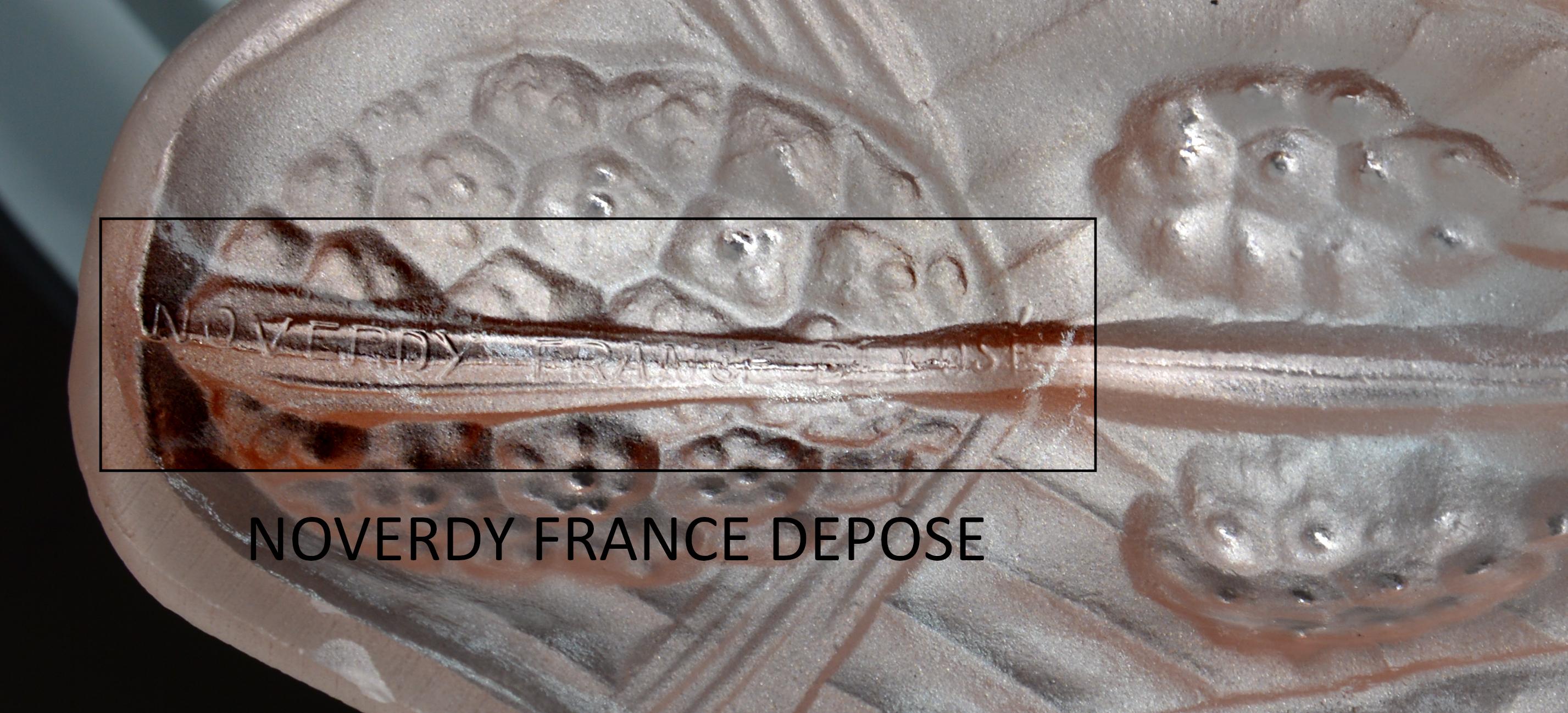 This stunning French Art Deco wall sconce, designed by Jean Noverdy (Dijon), France, circa 1920, features a thick salmon/pink molded glass shade that exudes elegance and vintage charm. The rare and beautiful wrought iron fixture complements the