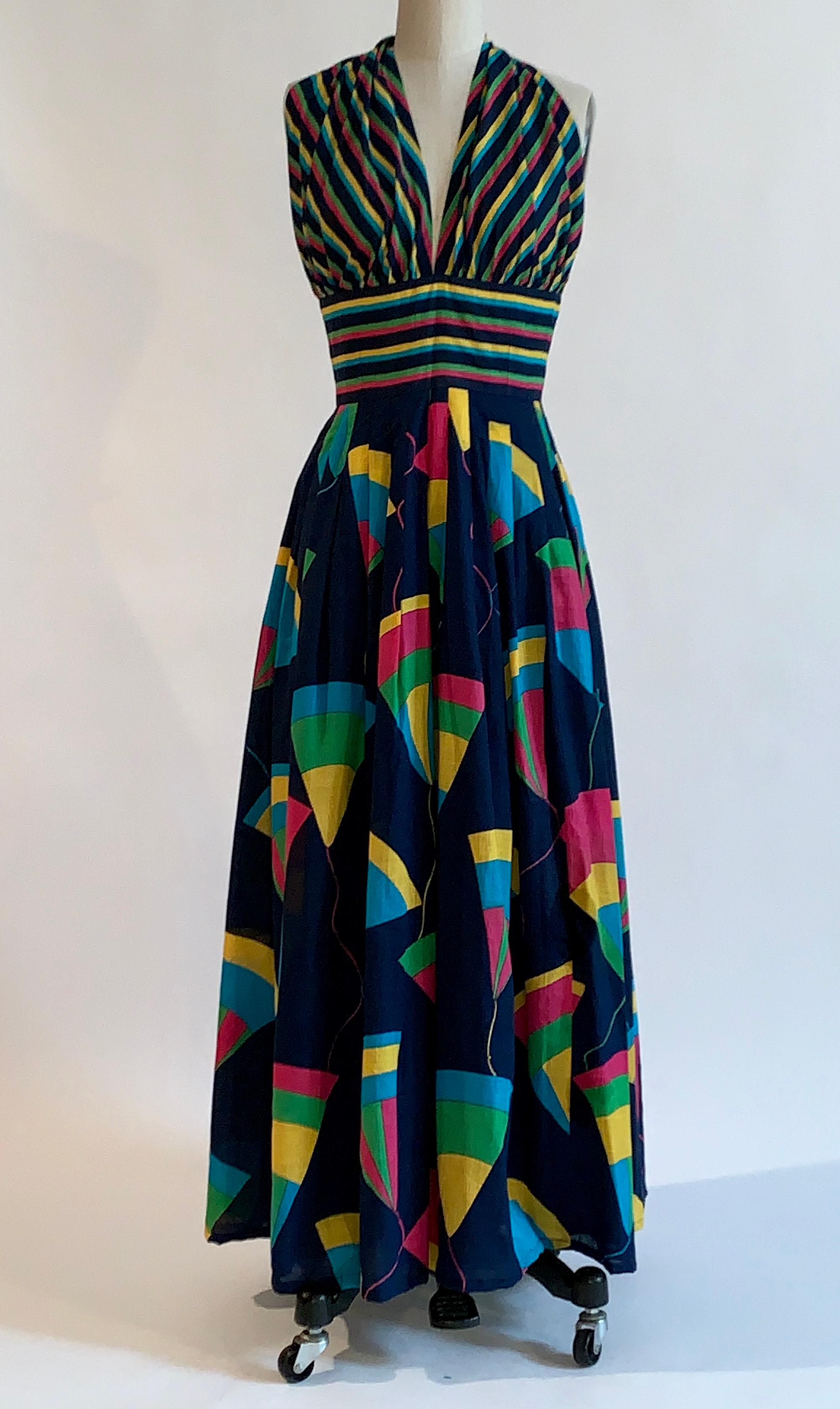 Jean Patou vintage 1970s maxi length sundress featuring navy, turquoise, pink, yellow and green stripes at halter top and geometric print at skirt. Back zip and hook. 

Content not listed, feels like cotton.
Lined from waist to hem.

Made in
