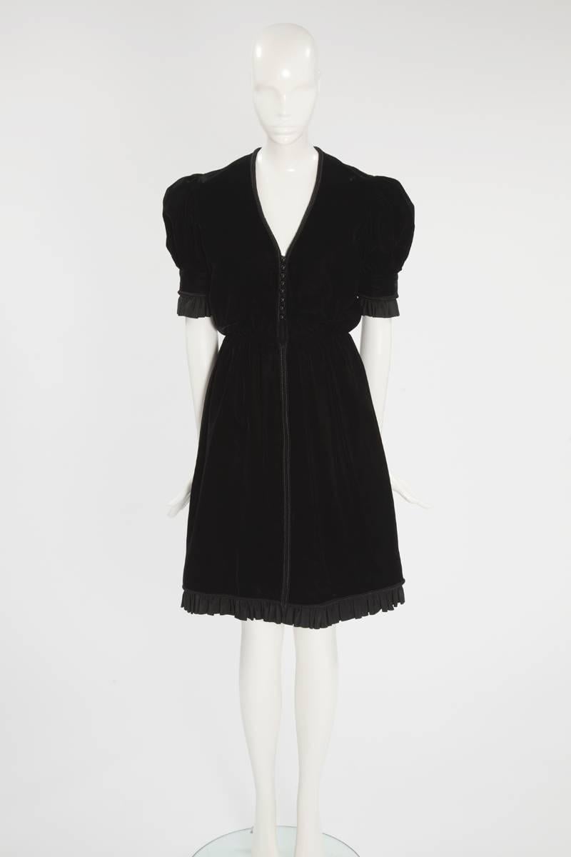 Perfect for everything from cocktail parties to dinners, this wonderful 60’s Jean Patou “little black dress” has a “dirndl” feel. Constructed in black velvet, the dress features puffed shoulders with a ruffled mate silk taffeta around the sleeves