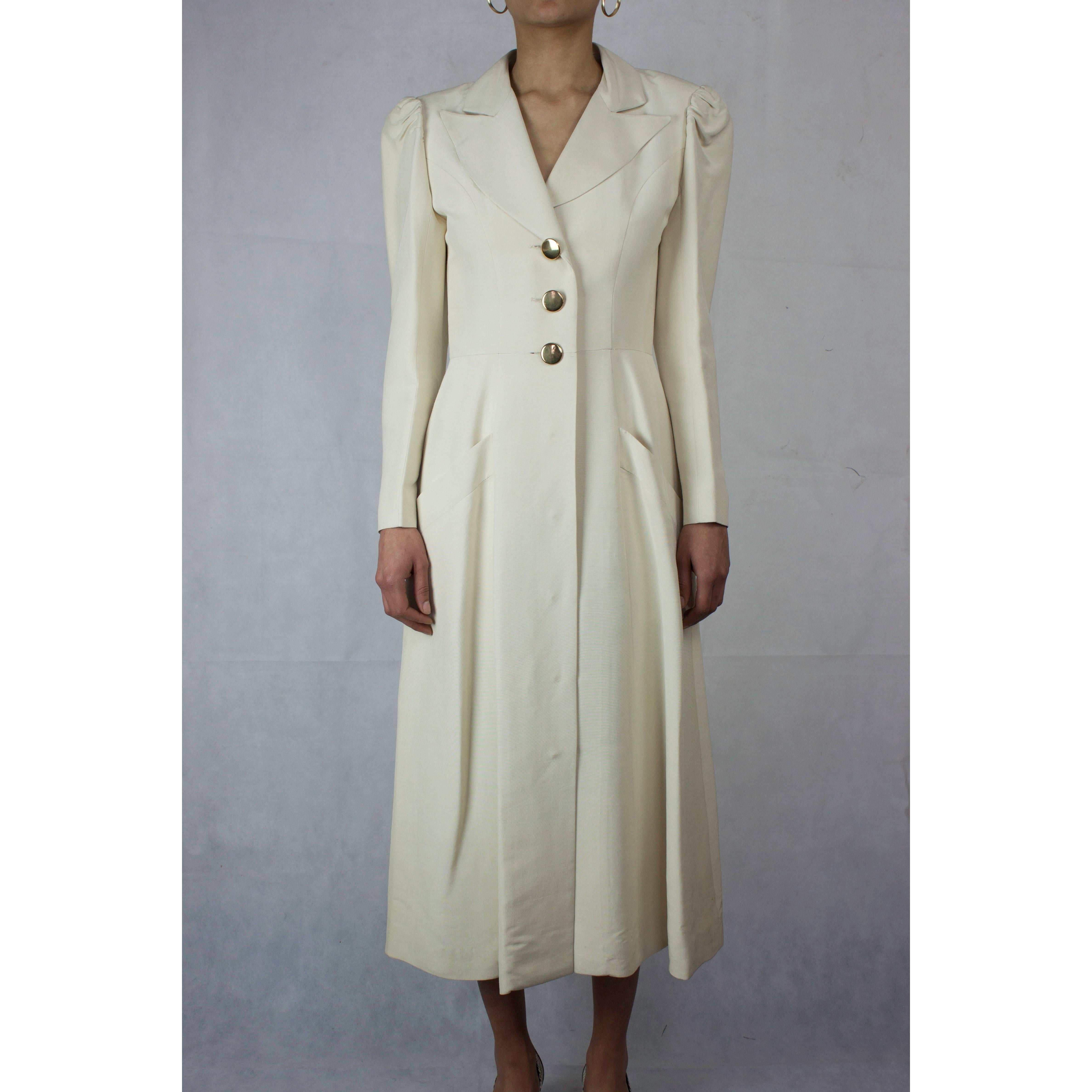 
In the 1960s formal wear had a fresh new look. 
Simpler and straighter lines inspired by military and ecclesiastical tailoring signalled the beginning of modern and contemporary fashion.
This elegant coat inspired by the full length garment worn by