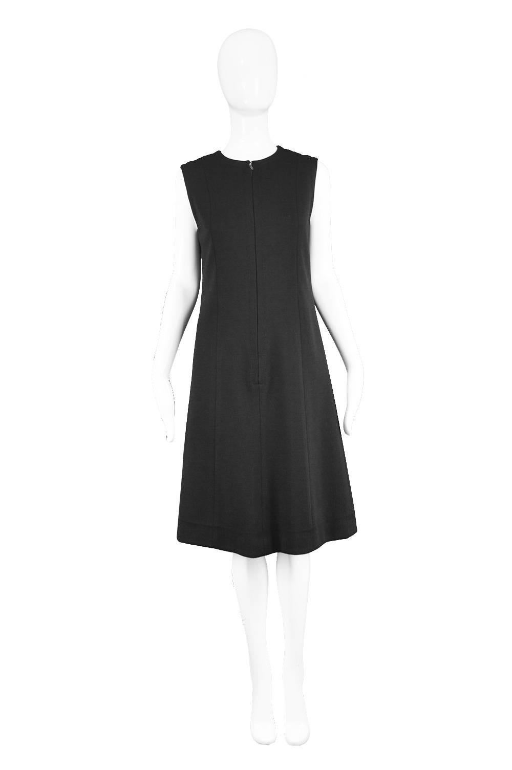 Jean Patou Vintage 1960s Black Wool Sleeveless Mod Cocktail Shift Dress 

Estimated Size: UK 10/ US 6/ EU 38. Please check measurements.
Bust - 34” / 86cm
Waist - 32” / 81cm
Hips - 38” / 96cm
Length (Shoulder to Hem) - 39” / 99cm

Condition: