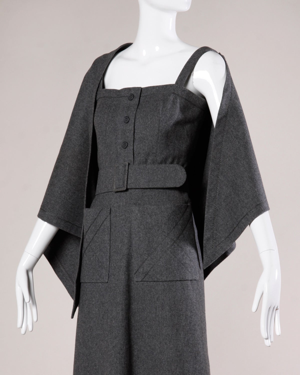 Stunning Jean Patou ensemble in luxurious medium weight gray wool featuring a sleeveless maxi dress, matching belt and matching wrap. Gorgeous quality and construction. All pieces can be worn together as ensemble or separately. 

Details:

Fully