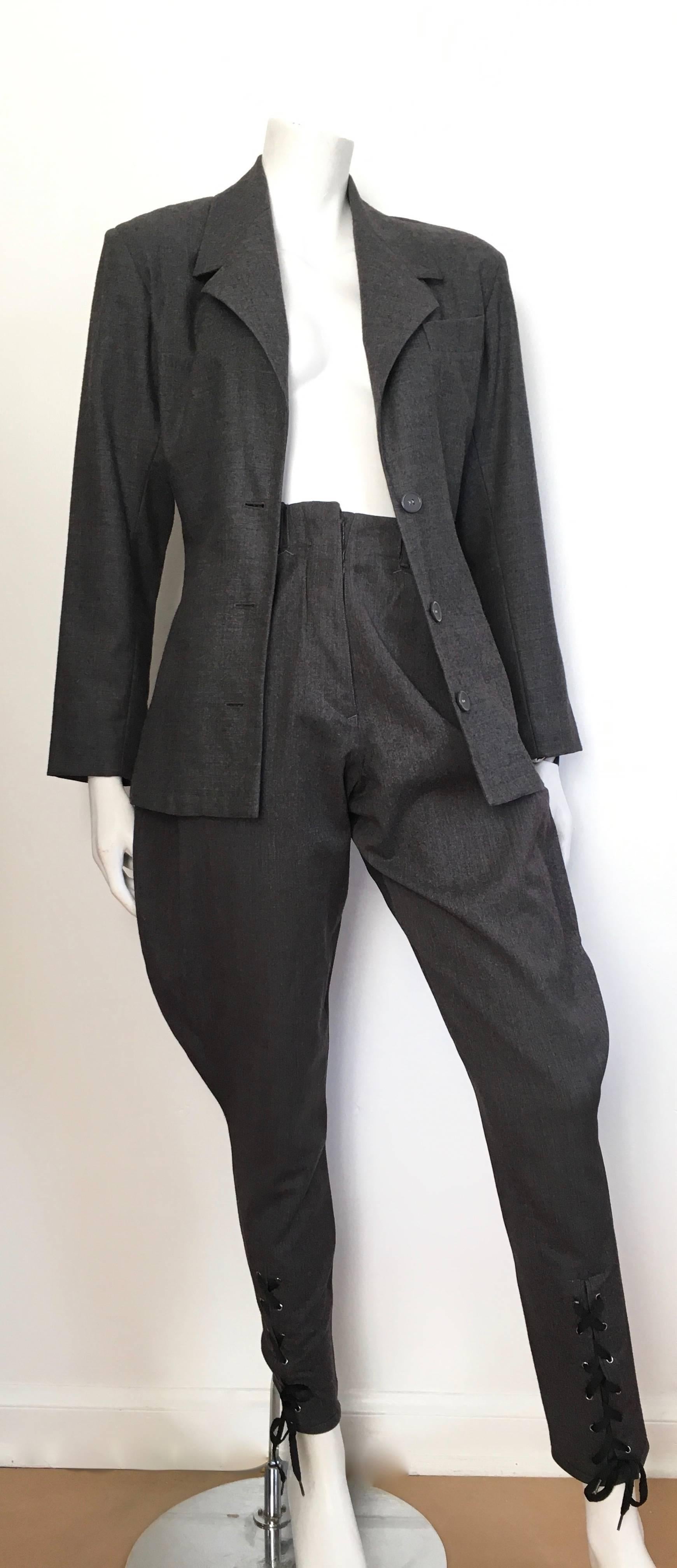 Jean Paul Gaultier 1980s grey wool jacket & lace up jodhpur pants is a size 4. The jacket is sized an Italian size 42 and the pants are size 40. The client who consigned this piece purchased it in Paris back in the 80s and she is a size 4. The waist
