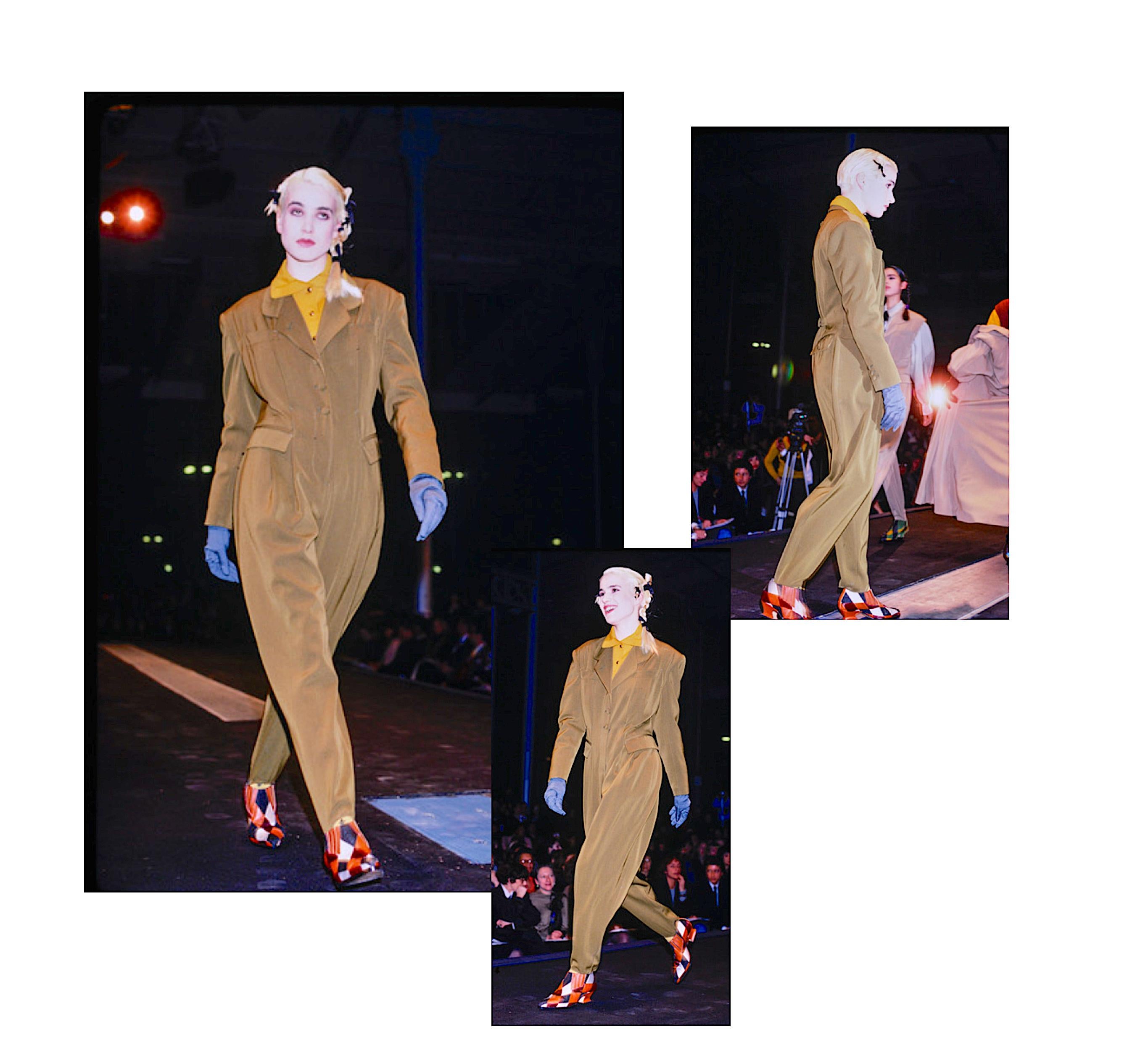 A wonderful and perfectly tailored vintage 1980s black jumpsuit by Jean-Paul Gaultier.
The front of the jumpsuit has three fabric-covered buttons and a zipper for closure. 
It features four pockets + a buttonhole in the lapel. The back of the
