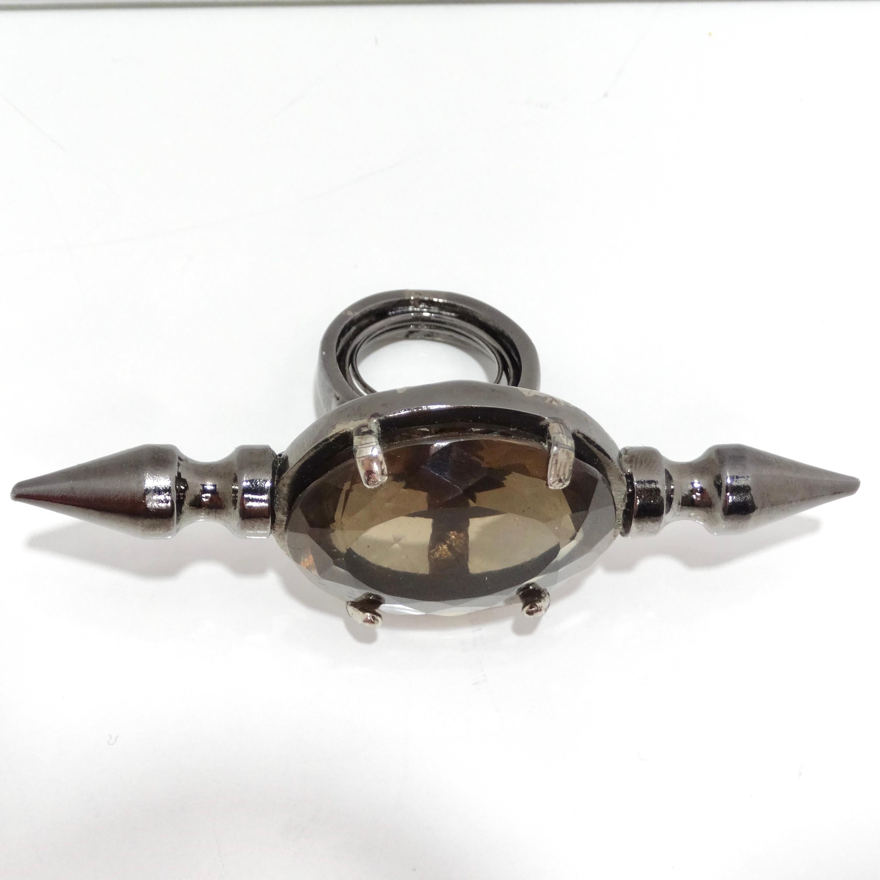 Elevate your style with the Jean Paul Gaultier 1990s Jumbo Smoky Quartz stud Ring, a truly unique and super rare accessory. This jumbo statement ring features a large smoky quartz center stone that exudes an air of sophistication. What sets this