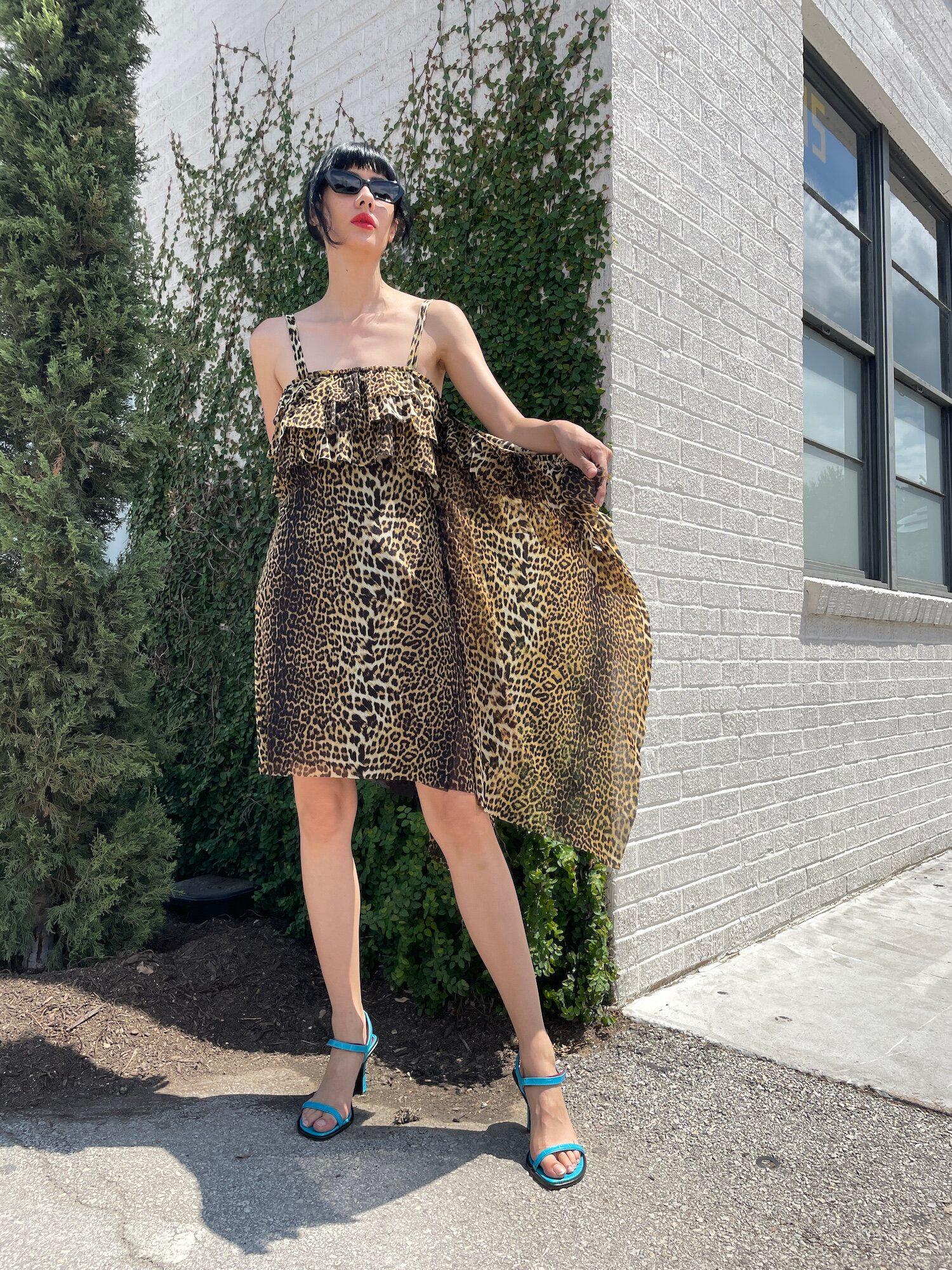 Vintage Jean Paul Gaultier 1990s Leopard Asymmetrical Cheetah Animal Print 90s Mesh Ruffled Midi Dress
This party dress features an all over animal print with a long asymmetrical ruffle running down the left side. The bust also features rows of