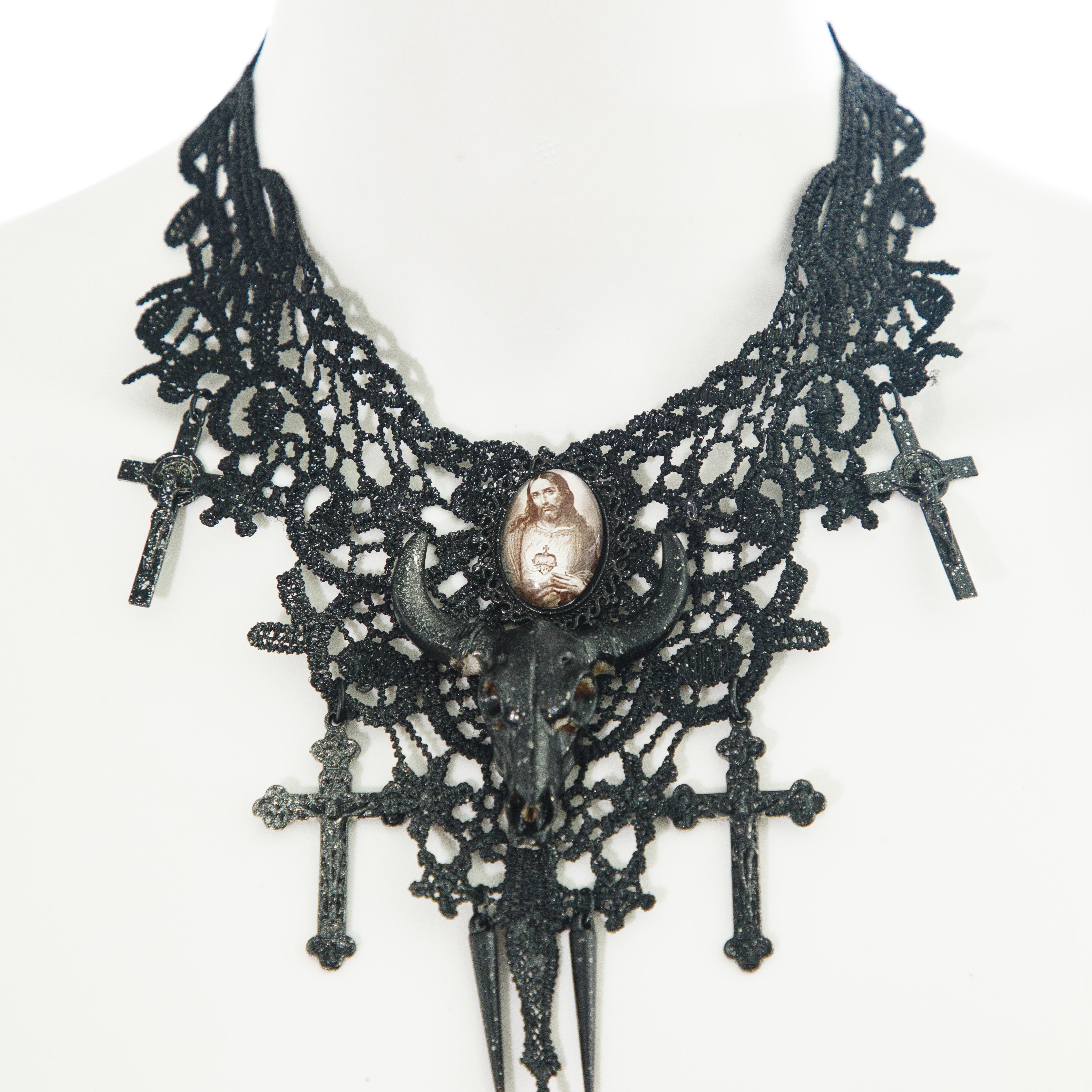 Ruder Than The Rest presents a 1 of 1 sample Jean Paul Gaultier lace bound crucifix necklace circa 1994.

Black speckled enamel finish.

Depiction of Jesus in the centre.

Fine details on the front and back of the piece.

Vintage, circa